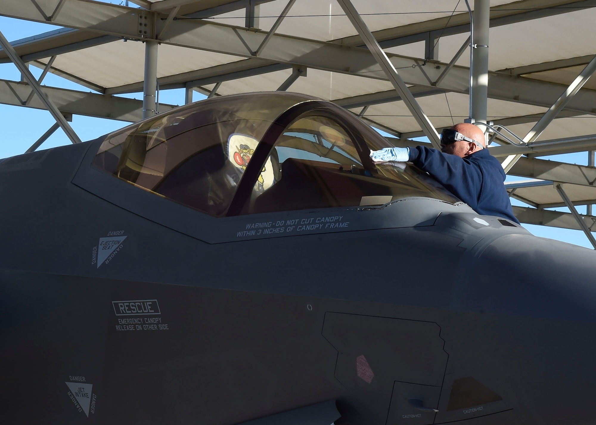 Chad Thomson, 62nd Aircraft Maintenance Unit Lockheed Martin crew chief, stands by to marshal an F-35 Lightning II Jan. 24, 2017, at Luke Air Force Base, Ariz. The 62nd AMU is in the process of integrating Airmen into its maintenance operations. (U.S. Air Force photo by Senior Airman James Hensley)
