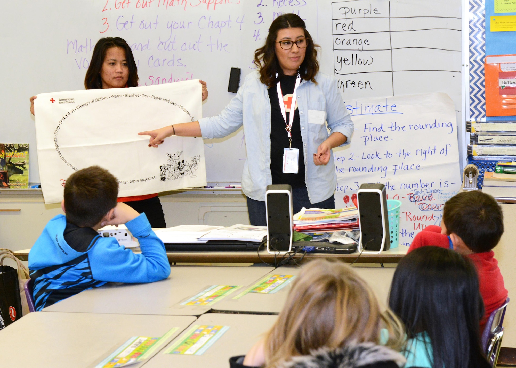 American Red Cross volunteers Cecilia Olivas (center) and Simone Delaflor Evangelista talk to fourth graders at Irving L. Branch Elementary Jan. 19 about the Red Cross’ Pillowcase Project. The project encourages third-fifth-graders to learn about emergency preparedness. (U.S. Air Force photo by Kenji Thuloweit)