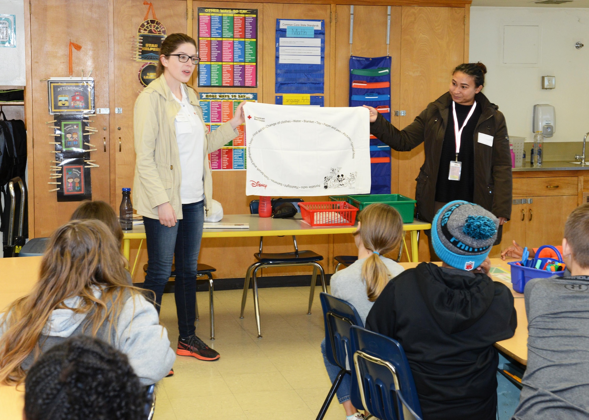 From left: American Red Cross volunteers Haley Seibel and Tamara Alcantara talk to fourth-graders at Irving L. Branch Elementary Jan. 19 about the Red Cross’ Pillowcase Project. Subjects touched on by the volunteers included managing stress during an emergency; what to do in case of a fire or earthquake; and what items the children should pack during an emergency in their pillowcase. (U.S. Air Force photo by Kenji Thuloweit)