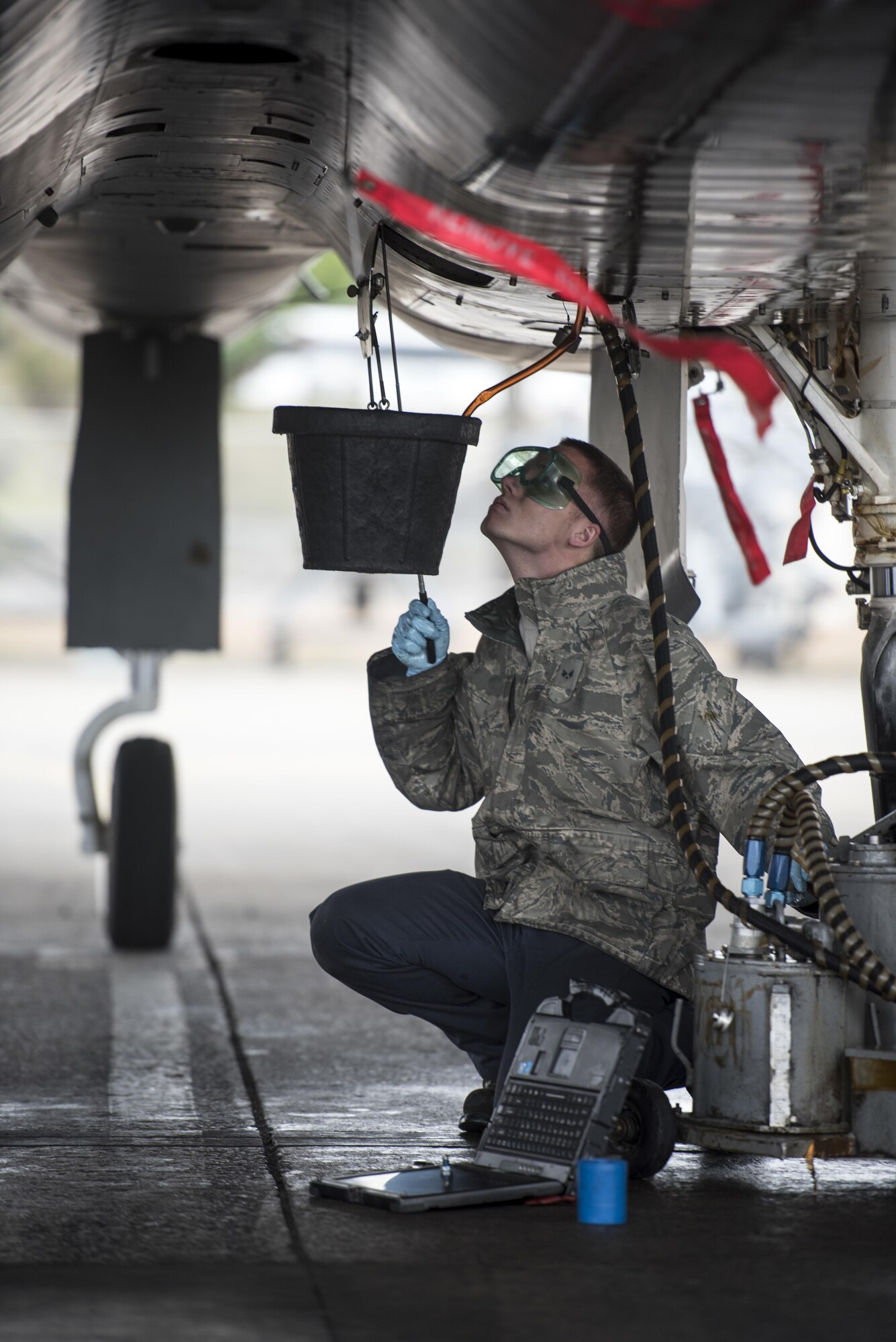 U.S. Air Force Senior Airman Dyllan Jones, 67th Aircraft Maintenance Unit F-15 Eagle crew chief changes the oil of an F-15 Eagle Jan 10, 2017, at Kadena Air Base, Japan. The F-15 Eagle is an all-weather, extremely maneuverable, tactical fighter designed to permit the Air Force to gain and maintain air supremacy over the battlefield. (U.S. Air Force photo by Senior Airman Omari Bernard/Released)