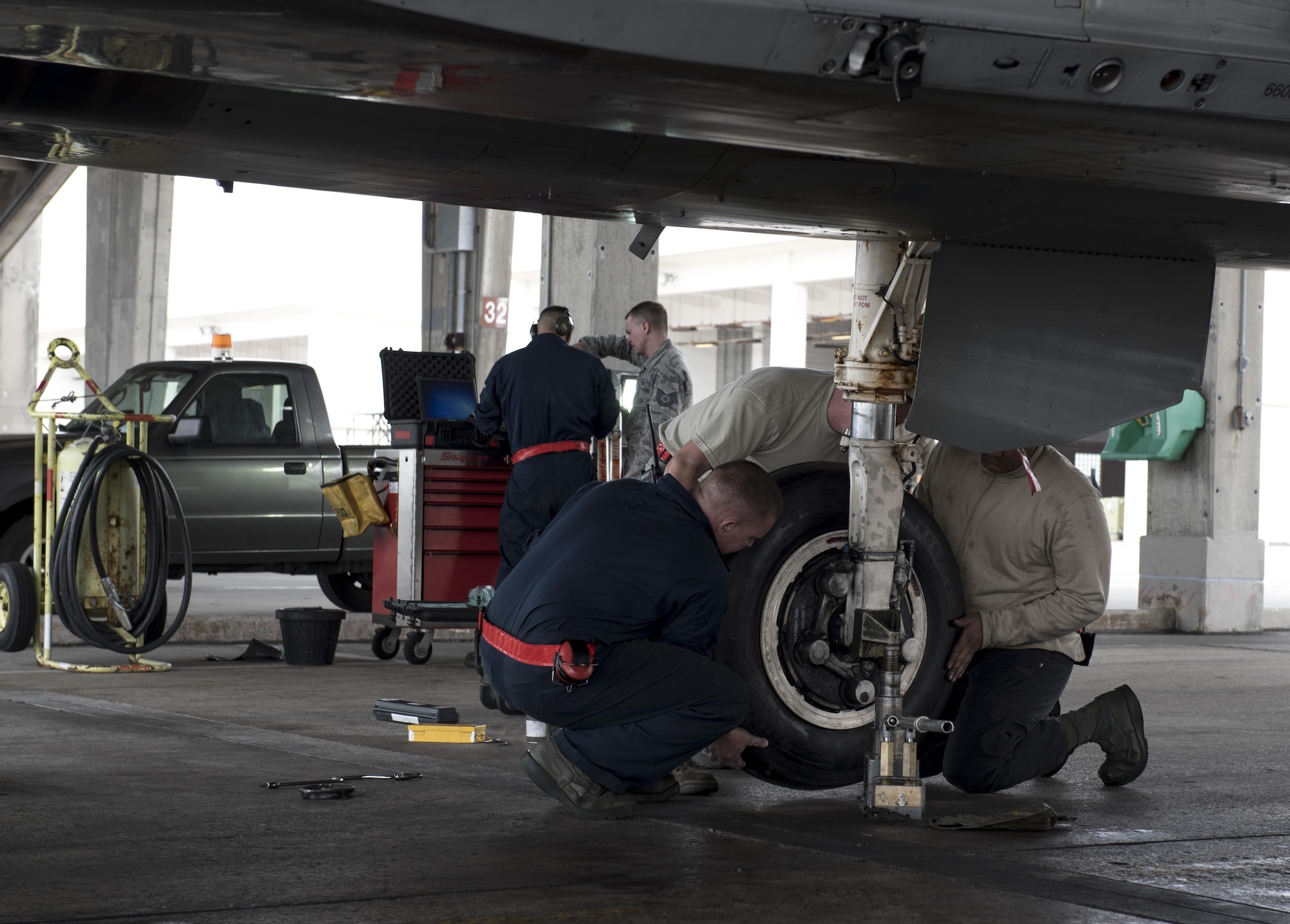 U.S. Air Force 67th Aircraft Maintenance crew chiefs place a new tire onto an F-15 Eagle Jan 10, 2017, at Kadena Air Base, Japan. 67th AMU maintainers are on constant standby to ensure Kadena’s F-15 Eagles are able to deploy at a moment’s notice. (U.S. Air Force photo by Senior Airman Omari Bernard/Released)
