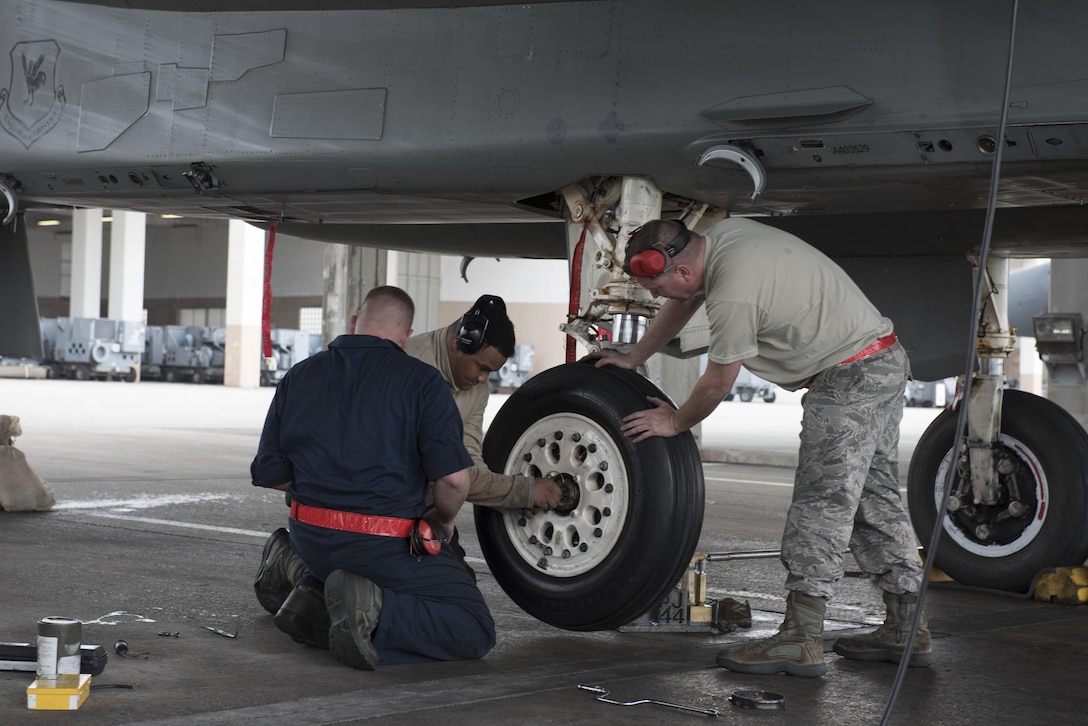 U.S. Air Force 67th Maintenance Unit crew chiefs work together to quickly and safely change the deflated tire of an F-15 Eagle Jan 10, 2017, at Kadena Air Base, Japan. The 67th AMU maintainers work around the clock to ensure Kadena’s F-15s remain mission ready to defend and support U.S. and coalition partners’ interests throughout the Indo-Asia Pacific region. (U.S. Air Force photo by Senior Airman Omari Bernard/Released)