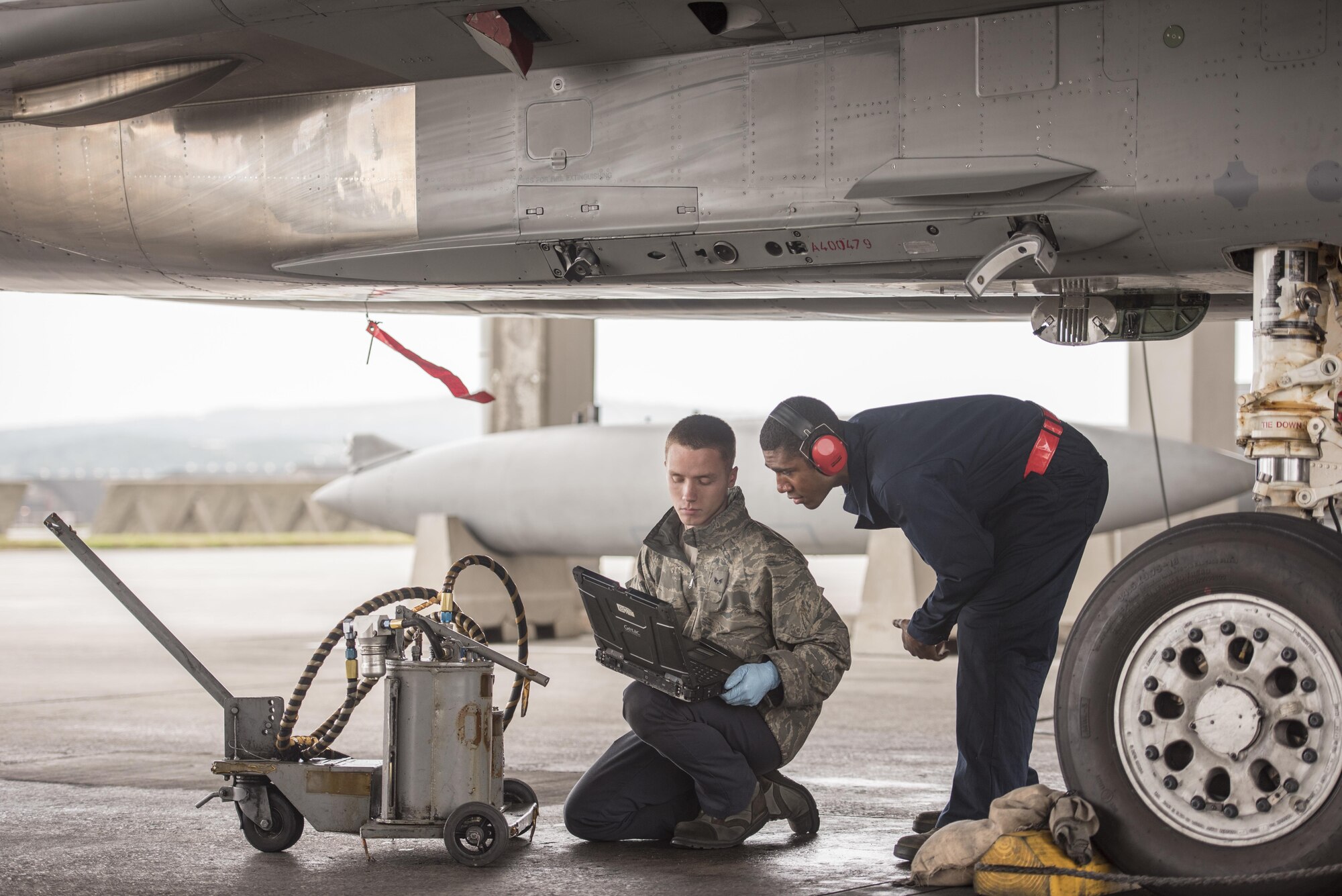 U.S. Air Force Senior Airman Dyllan Jones and Airman 1st Class Wesley Johnson, 67th Aircraft Maintenance Unit F-15 Eagle crew chiefs, check their technical orders during routine maintenance of an F-15 Eagle Jan 10, 2017, at Kadena Air Base, Japan. Technical orders help aircraft maintainers follow the correct procedures to diagnose and repair problems that can occur with aircraft. (U.S. Air Force photo by Senior Airman Omari Bernard/Released)