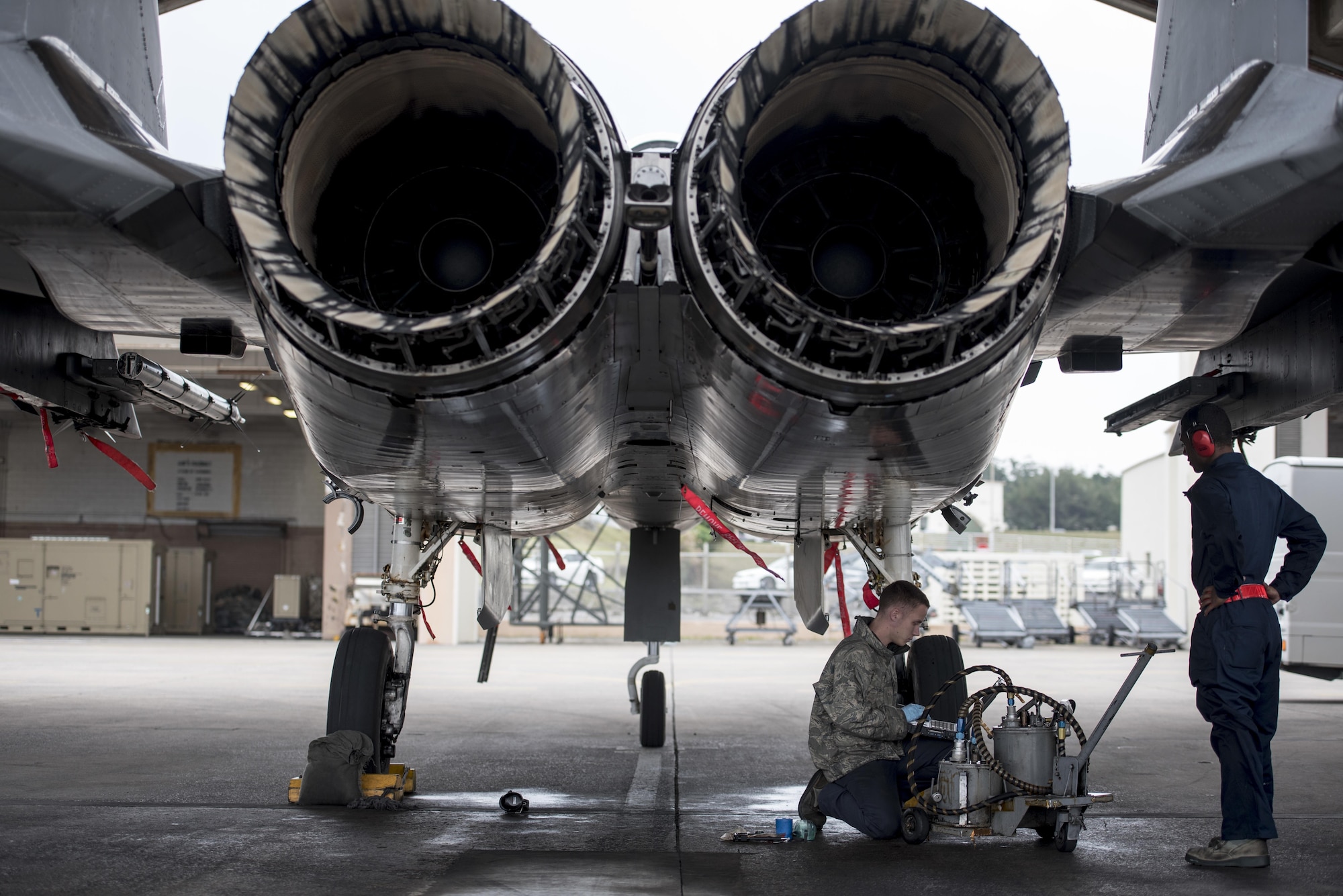 U.S. Air Force Senior Airman Dyllan Jones and Airman 1st Class Wesley Johnson, 67th Aircraft Maintenance Unit F-15 Eagle crew chiefs, maintain an F-15 Eagle Jan 10, 2017, at Kadena Air Base, Japan. Kadena Air Base is home to the U.S. Air Force’s largest combat wing. (U.S. Air Force photo by Senior Airman Omari Bernard/Released)