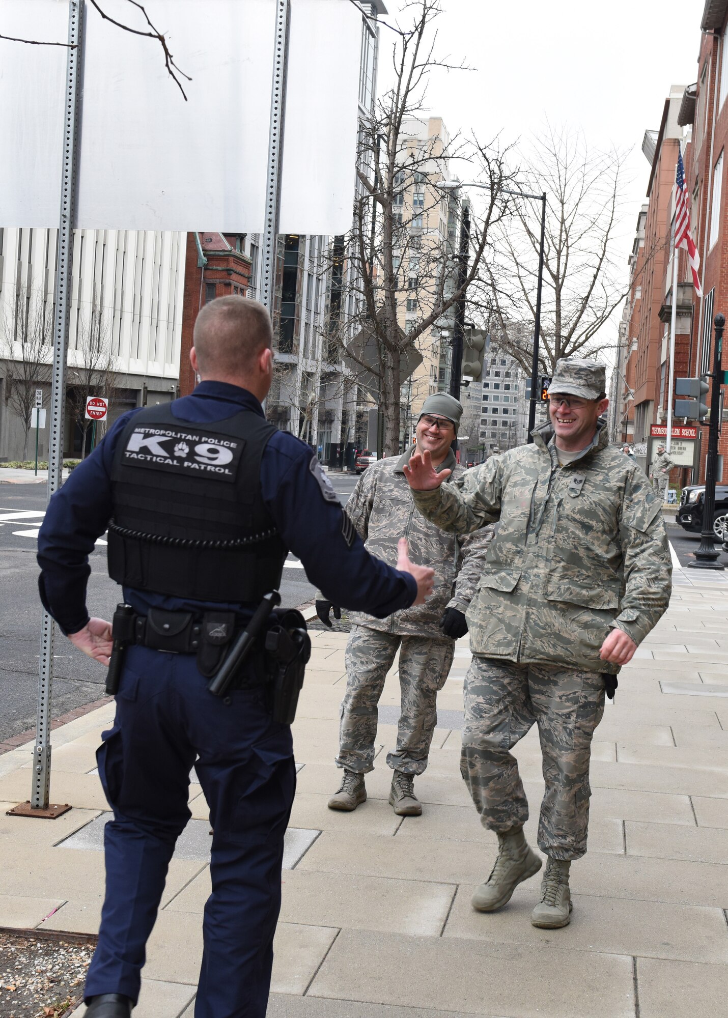 Staff Sgt. David Nichols (right), 193rd Special Operations Security Forces Squadron, and Sgt. Jeff Kopp (left), D.C. Metropolitan Police K-9 Corps, reunite on a D.C. street Jan. 20, 2017, while supporting security missions during the 58th Presidential Inauguration. Formerly serving as Marines, the two men deployed together in 2010 on several combat missions in Afghanistan. (U.S. Air National Guard photo by 2nd Lt. Susan Penning/Released)    