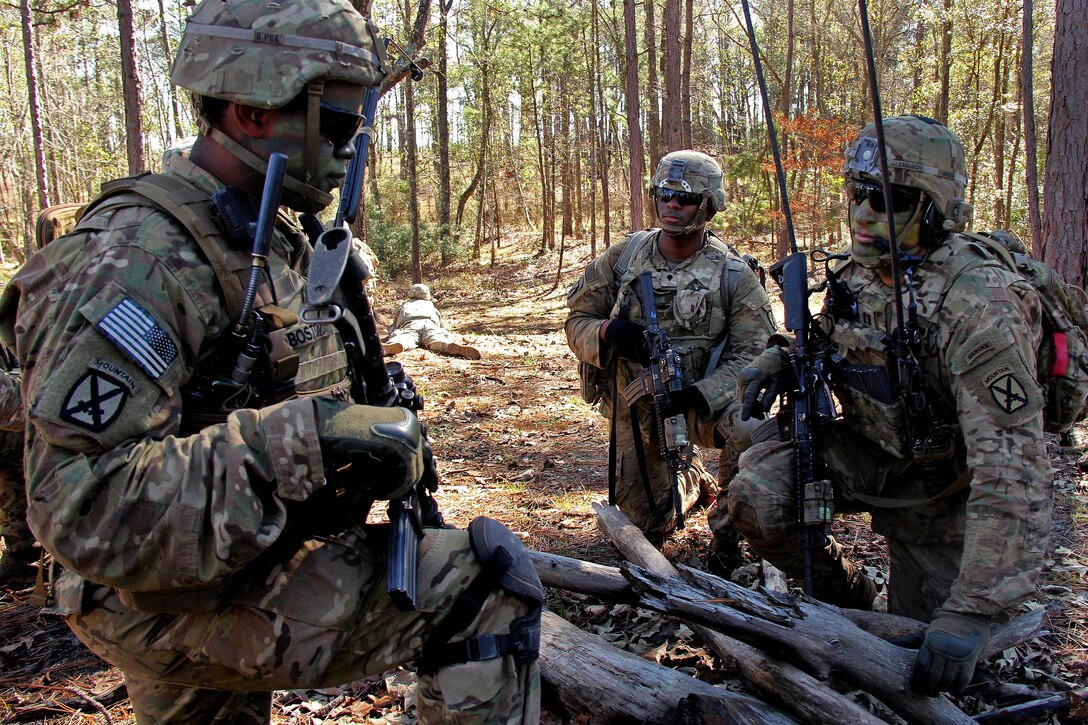 Soldiers discuss their next tactical movement during live-fire training as part of Joint Readiness Training Center Rotation 17-03 at Fort Polk, La., Jan. 21, 2017. Army photo