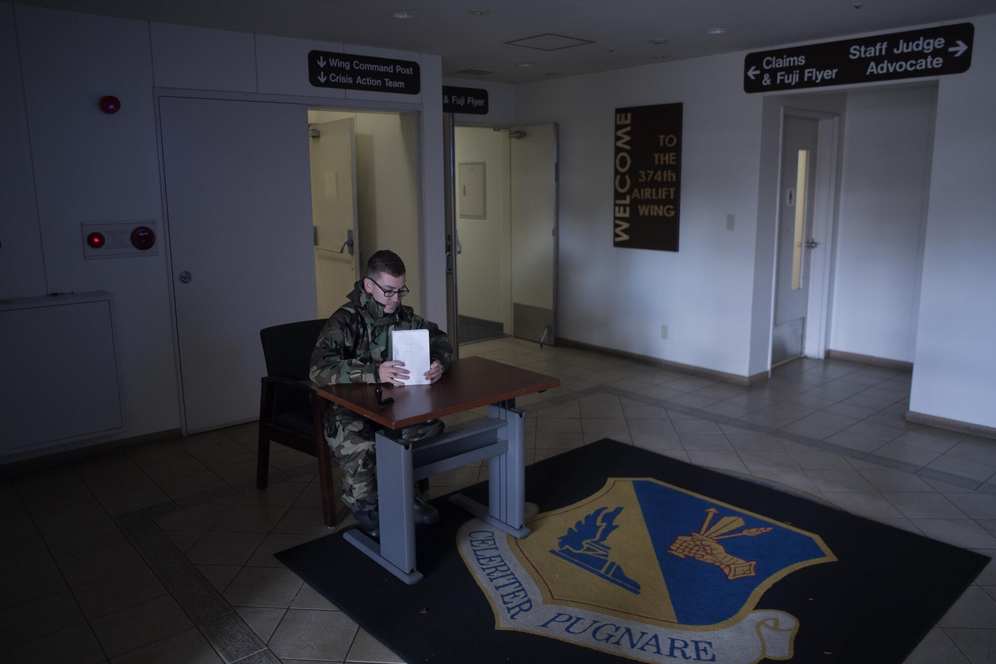 Staff Sgt. David Owsianka, 374th Airlift Wing public affairs photojournalist, prepares for door guard duty during a Samurai Readiness Training Day at Yokota Air Base, Japan, Jan. 23, 2017. Yokota Airmen donned Mission-Oriented Protective Posture gear to train for simulated MOPP levels during the training. (U.S. Air Force photo by Yasuo Osakabe)
