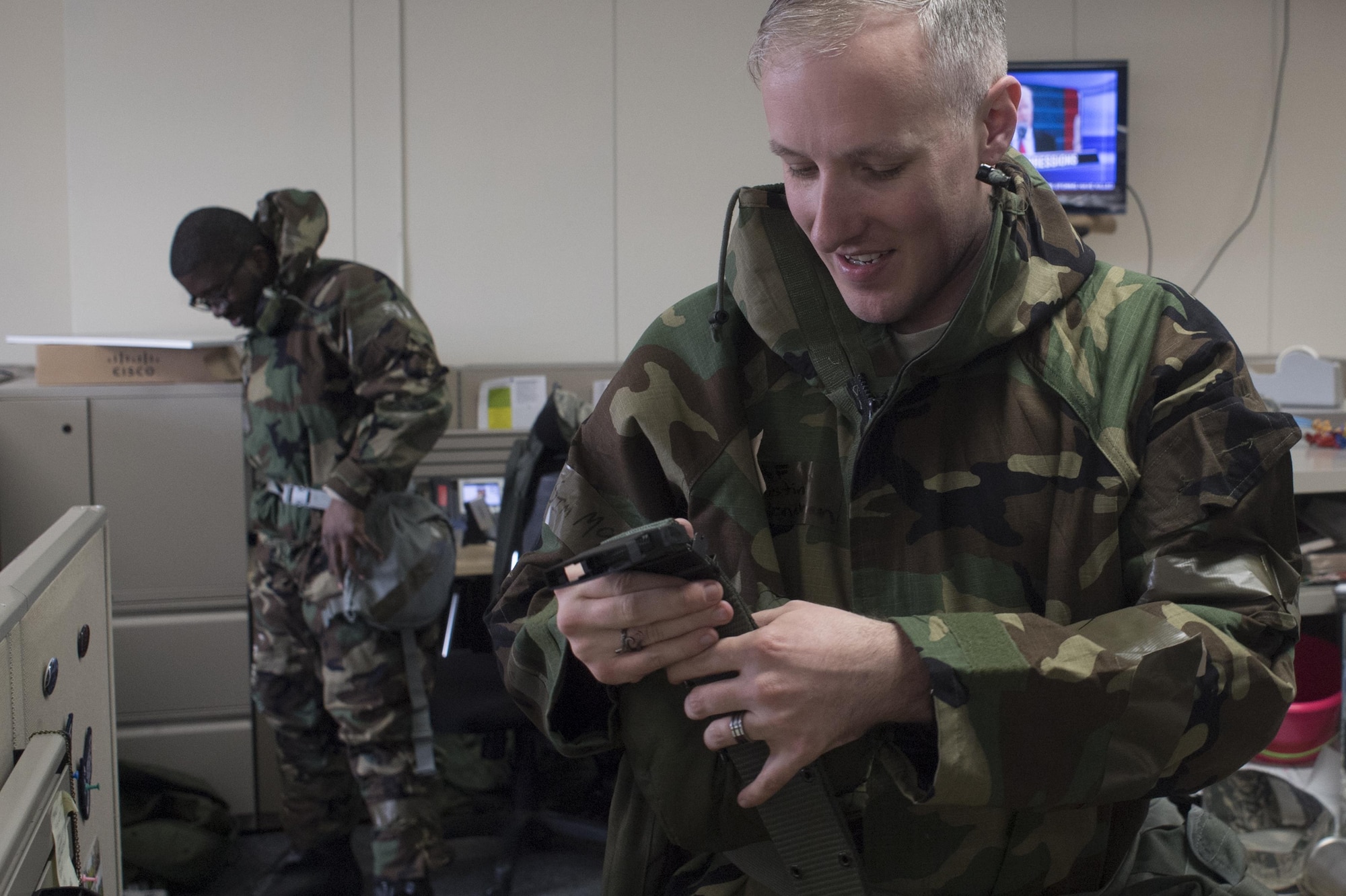 Senior Airmen Justin Carnahan, 374th Airlift Wing public affairs broadcaster, dons Mission-Oriented Protective Posture gears during a Samurai Readiness Training Day at Yokota Air Base, Japan, Jan. 23, 2017. Yokota airmen trained for different type of contingency for the ability to survive and operate during a variety of events. (U.S. Air Force photo by Yasuo Osakabe) 