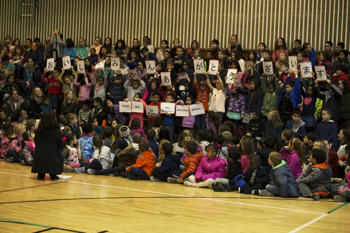 Matthew C. Perry Elementary School students hold up signs at the seventh annual mikan presentation at Marine Corps Air Station Iwakuni, Japan, Jan. 19, 2017. The host nation class’s signs read “Thank you for the delicious mikans!” in Japanese, English and Spanish. Local farmers presented the sweet, easy-to-peel citrus fruit, which is similar to Mandarin oranges, to students expanding their experience of Japanese cultures. (U.S. Marine Corps photo by Lance Cpl. Gabriela Garcia-Herrera)