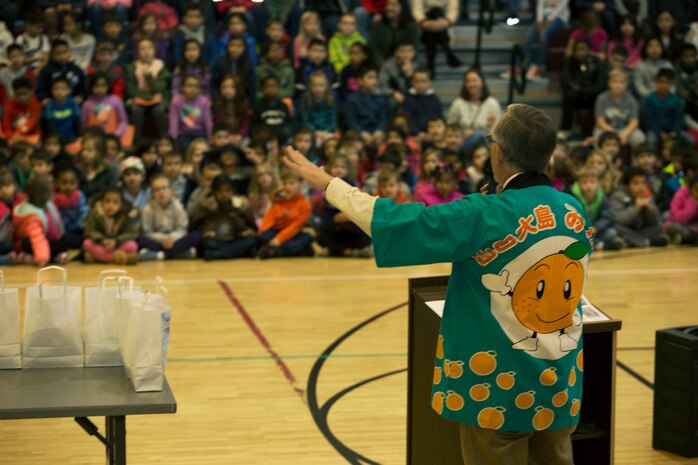 Larry Wahl, the psychologist for Matthew C. Perry Schools, adresses elementary school students during the seventh annual mikan presentation at Marine Corps Air Station, Iwakuni, Japan, Jan. 19, 2017. Local farmers presented the sweet, easy-to-peel citrus fruit, which is similar to Mandarin oranges, to students expanding their experience of Japanese cultures. (U.S. Marine Corps photo by Lance Cpl. Gabriela Garcia-Herrera)