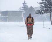 U.S. Air Force Airman 1st Class Branden Ingledue, a 13th Aircraft Maintenance Unit propulsions systems specialis, walks on the flight line at Misawa Air Base, Japan, Jan. 11, 2017. According to the 35th Fighter Wing safety office, Airmen are advised to wear layered clothing that allows enough decterity to perform the task at hand. (U.S. Air Force photo by Airman 1st Class Sadie Colbert)