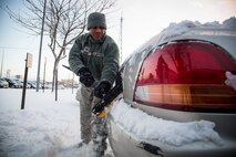 U.S. Air Force Staff Sgt. Dorian Lewis, a 35th Fighter Wing safety technician, removes snow from his vehicle at Misawa Air Base, Japan, Jan. 11, 2017. Base residents are advised to remove from car sides, windows, hood, license plates and the roof of the car, decreasing the dangers of driving during the winter. (U.S. Air Force photo by Airman 1st Class Sadie Colbert)