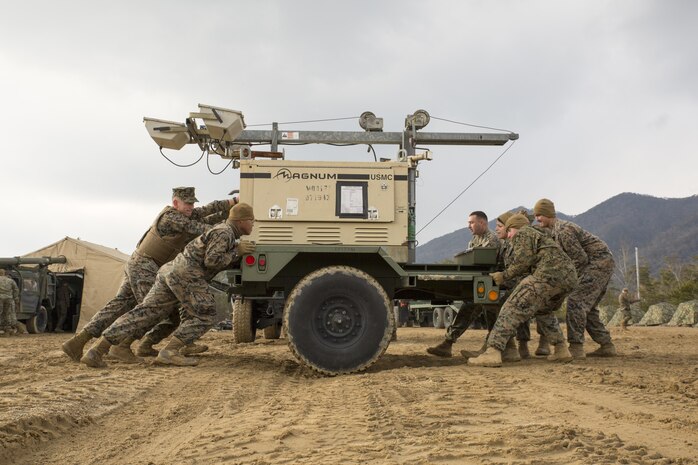 U.S. Marines with Marine Wing Support Squadron (MWSS) 171 move a flood light through the mud during exercise Kamoshika Wrath 17-1 at Japan Ground Self-Defense Force’s Haramura Maneuver Area in Hiroshima, Japan, Jan. 22, 2017. The exercise is a biannual, unit-level training exercise that is primarily focused on establishing a forward operating base and providing airfield operation services. MWSS-171 trains throughout the year completing exercises like Kamoshika Wrath 17-1 to enhance their technical skills, field experience and military occupational specialty capability. (U.S. Marine Corps photo by Cpl. Donato Maffin)