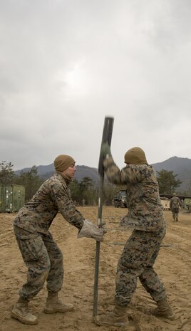 U.S. Marine Corps Lance Cpl. Simon Gomez, left, and Lance Cpl. Ryan Miston, both combat engineers with Marine Wing Support Squadron (MWSS) 171, drive stakes into the ground during exercise Kamoshika Wrath 17-1 at the Japan Ground Self-Defense Force’s Haramura Maneuver Area in Hiroshima, Japan, Jan. 22, 2017. The exercise is a biannual, unit-level training exercise that is primarily focused on establishing a forward operating base and providing airfield operation services. The squadron plans to construct a landing zone, conduct day and night security patrols and a live-fire range. (U.S. Marine Corps photo by Cpl. Donato Maffin)