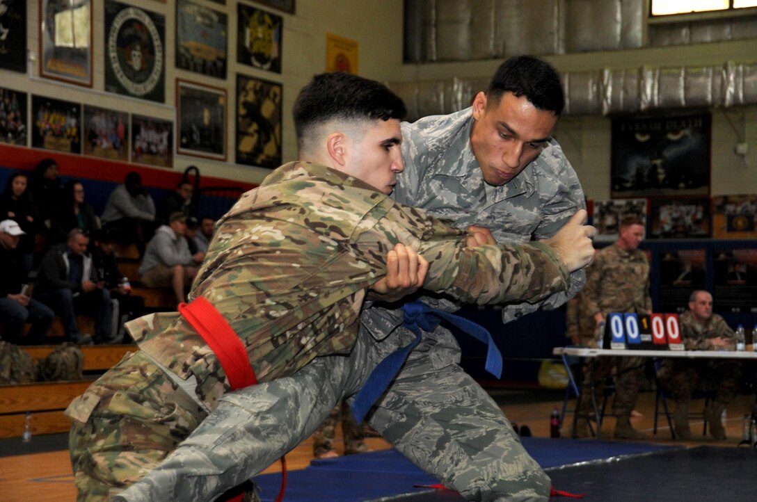 Senior Airman Dominic Rivera, 386th Expeditionary Maintenance Squadron craftsman, throws Spc. James Holder, 518th Tactical Installation Network, during an Army combatives tournament at an undisclosed location in Southwest Asia January 22, 2017. The tournament, hosted by the 368th Engineering Battalion, was open to all branches of the military to see who was the best fighter. (U.S. Air Force photo/Tech. Sgt. Kenneth McCann)