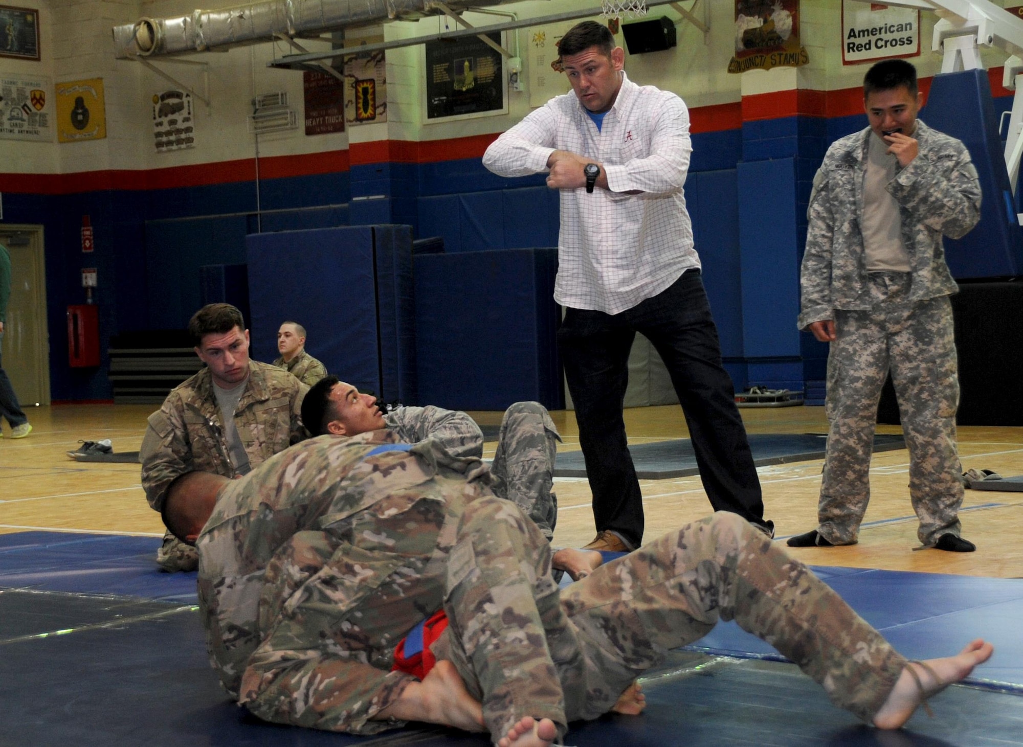 Master Sgt. Royce Kerbow 386th Air Expeditionary Wing command post superintendent, coaches his student during an Army combatives tournament match at an undisclosed location in Southwest Asia January 22, 2017. Kerbow prepared his students with daily Brazilian jujitsu work outs. (U.S. Air Force photo/Tech. Sgt. Kenneth McCann)