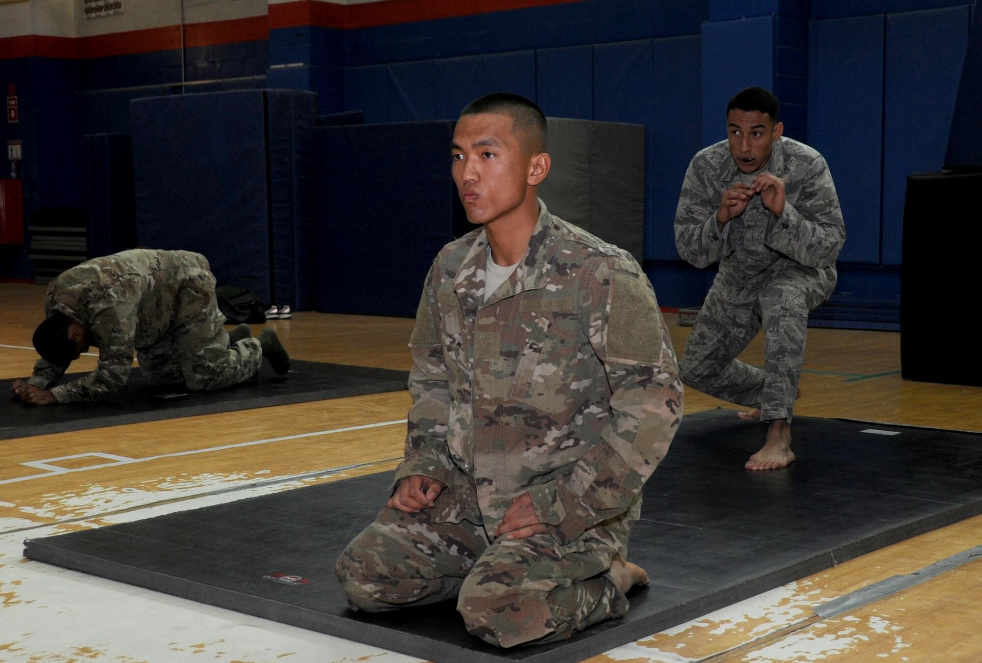 Pfc. Pham Viet, Delta 144th Air Defense Artillery wheel mechanic, left, and Senior Airman Dominic Rivera, 386th Expeditionary Maintenance Squadron craftsman, right, stretch before a fight during an Army combatives tournament at an undisclosed location in Southwest Asia January 22, 2017. Viet and Rivera both trained daily together to prepare themselves for the mixed martial arts competition. (U.S. Air Force photo/Tech. Sgt. Kenneth McCann)