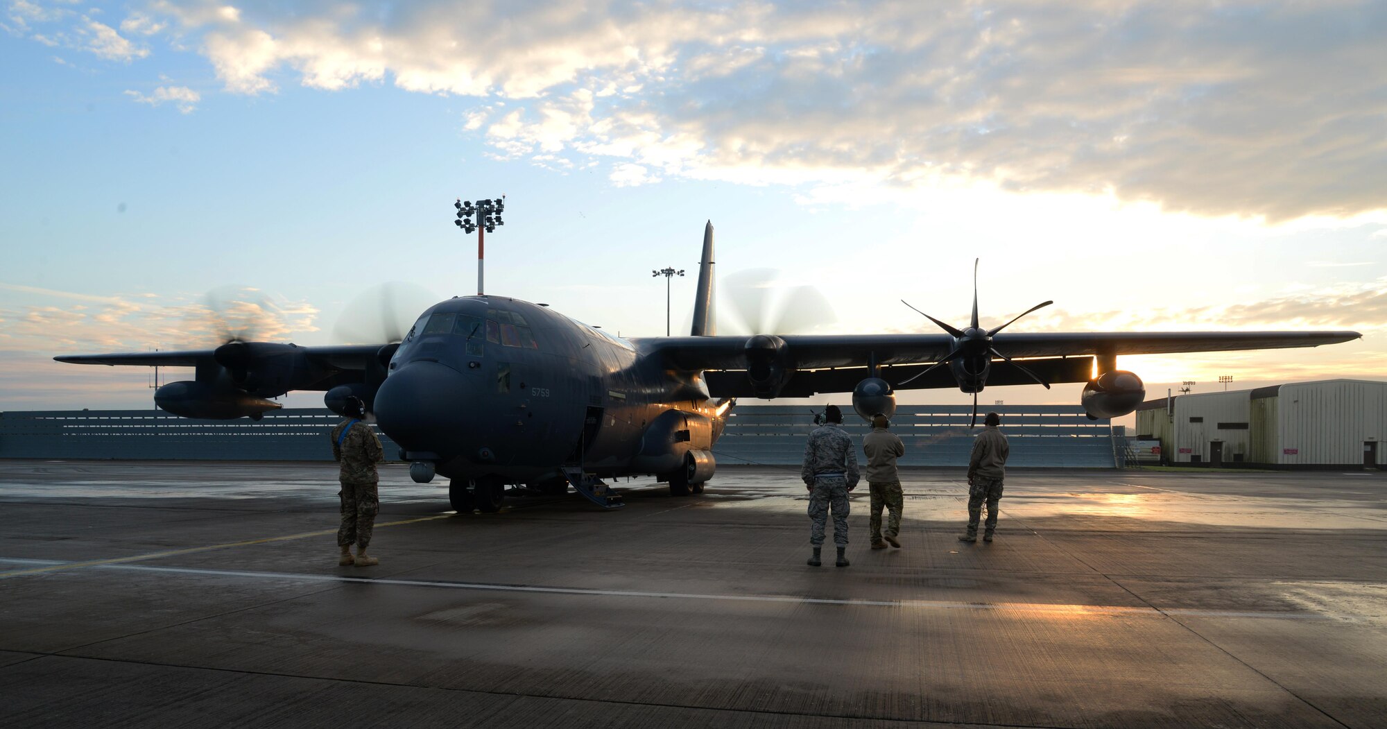 U.S. Air Force maintainers and aircrew assigned to the 352d Special Operations Wing look on as an MC-130J Commando II from the 67th Special Operations Squadron starts its engines Jan. 17, 2017, on RAF Mildenhall, England. Freezing temperatures require extra procedures, like de-icing, to avoid damage to the aircraft. (U.S. Air Force photo by Senior Airman Justine Rho)