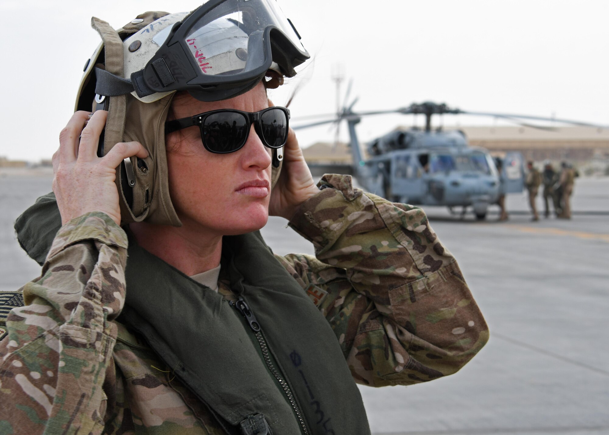 U.S. Air Force 1st Lt. Bridget Henry, a critical care nurse with the 379th Expeditionary Medical Group, dons a helmet during a flight safety briefing at Al Udeid Air Base, Qatar, Jan. 23, 2016. Henry was part of a mobile forward surgical team - expeditionary critical care team taking part in an exercise onboard the HMS Ocean, the Royal Navy’s flagship. (U.S. Air Force photo by Senior Airman Miles Wilson)