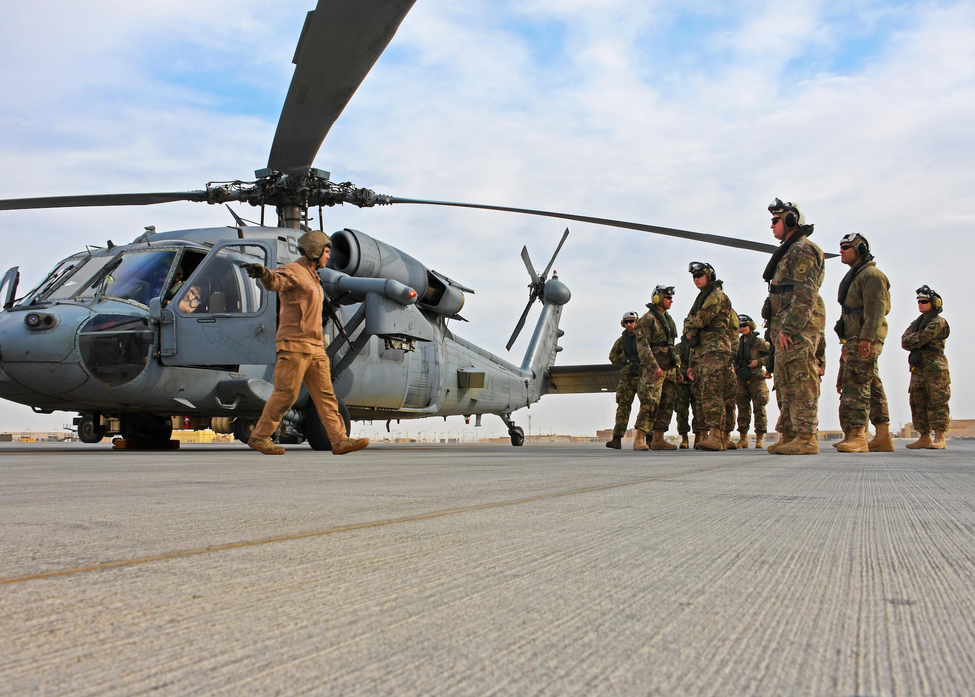 U.S. Air Force Airmen with the 379th Expeditionary Medical Operations Squadron prepare to board an MH-60 Seahawk at Al Udeid Air Base, Qatar, Jan. 23, 2017. Two Seahawks transported Airmen to the HMS Ocean, a Royal Navy ship, where they participated in a coalition exercise involving various medical drills at sea. (U.S. Air Force photo by Senior Airman Miles Wilson)