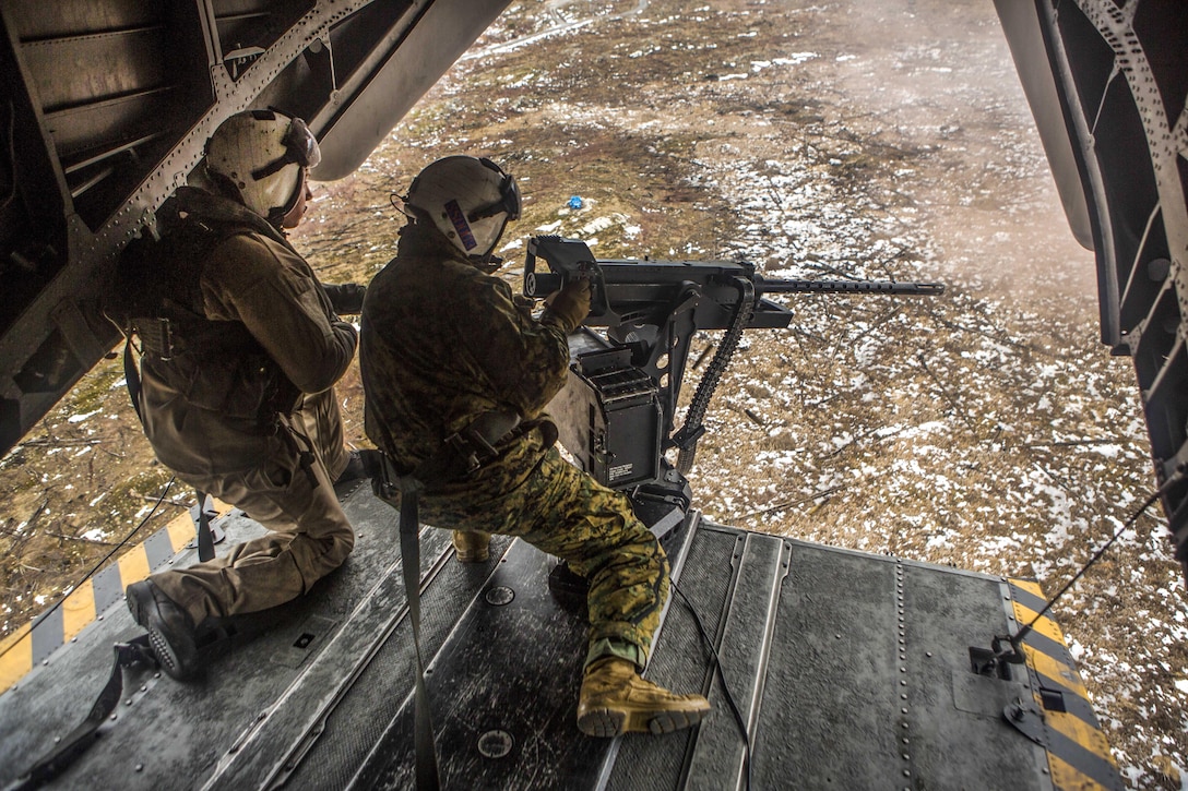 Marine Corps Sgt. Maj. Brian S. Alsleben, right, fires a .50-caliber machine gun while participating in a live-fire event as part of Exercise Frigid Condor over Fort Drum, N.Y., Jan. 23, 2017. Marine Corps photo by Lance Cpl. Jered T. Stone