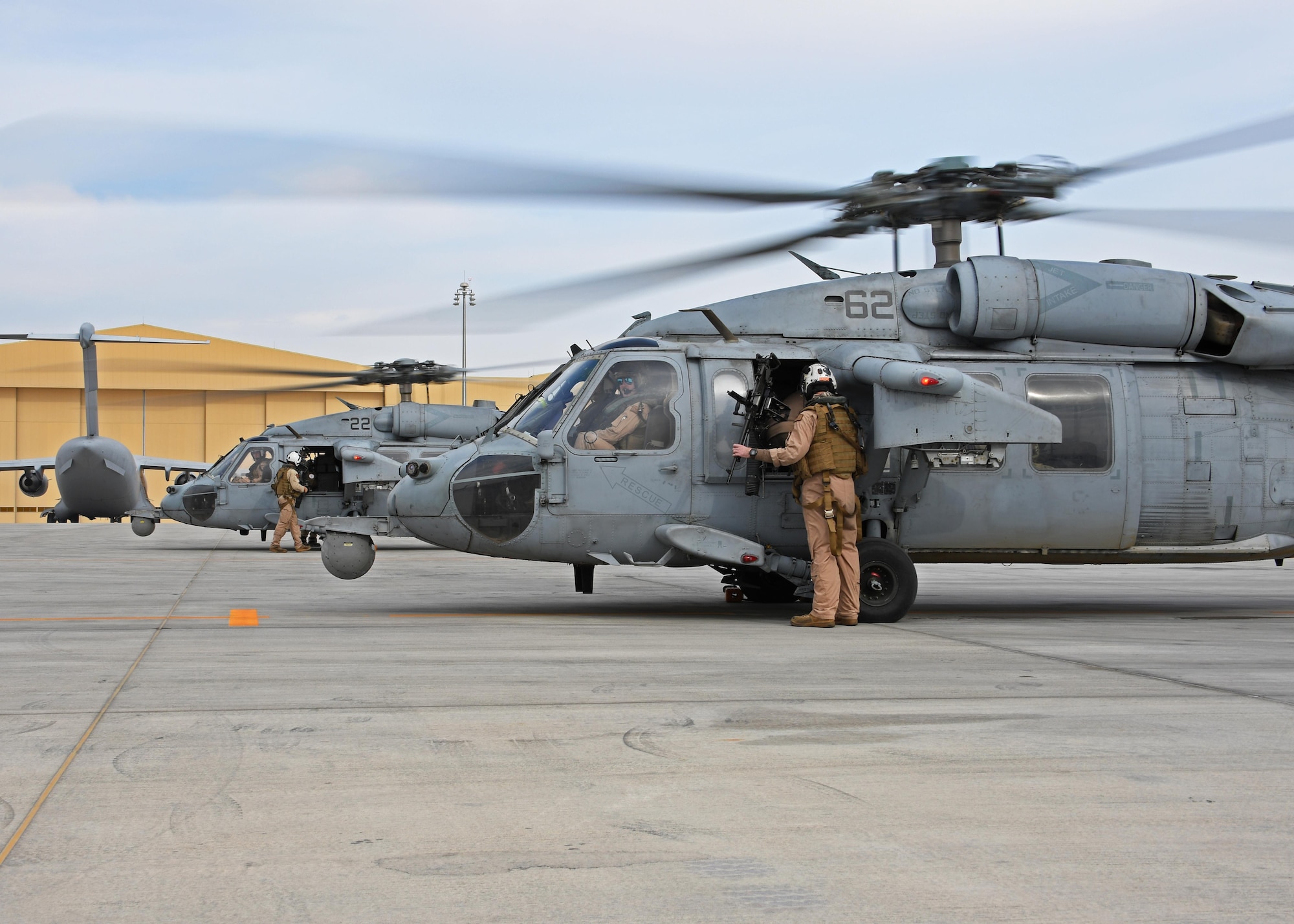 Two U.S. Navy MH-60 Seahawks prepare to takeoff from Al Udeid Air Base, Qatar, Jan. 23, 2017. The helicopters were loaded with medical personnel with the 379th Expeditionary Medical Operations Squadron mobile field surgical and expeditionary critical care teams who were being transported to the HMS Ocean, a Royal Navy ship currently deployed within the Mediterranean, for a coalition medical exercise. (U.S. Air Force photo by Senior Airman Miles Wilson)