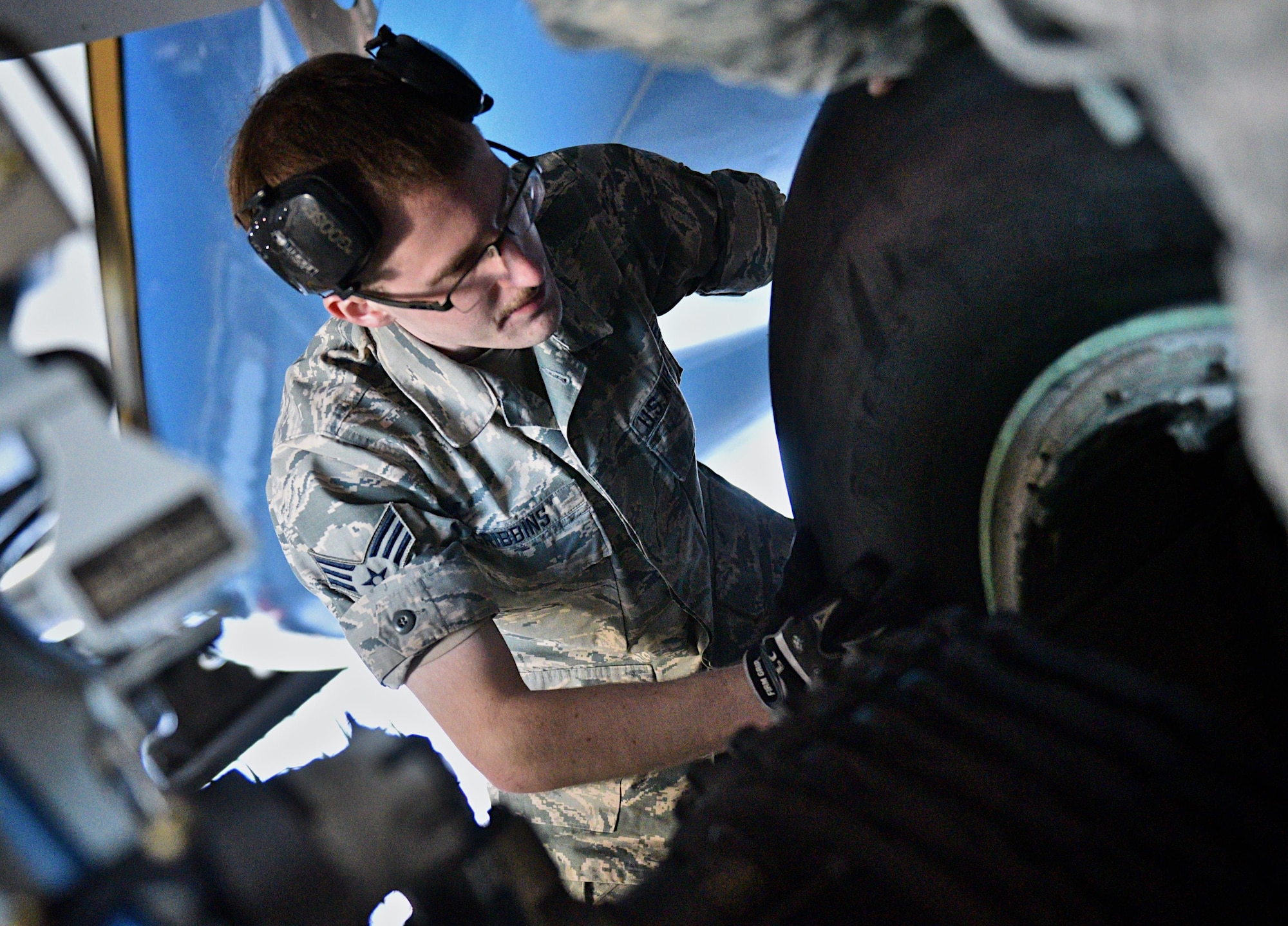 Senior Airman Anthony Gribbins, C-40 maintainer with the 932nd Airlift Wing Maintenance Squadron assists with a routine tire change inside Hangar 1 Dec. 29, 2016 at Scott Air Force Base, Illinois. Worn tires get swapped out weekly on any one of the four C-40 aircraft maintained by the 932nd MXS. (U.S. Air Force photo by Christopher Parr)