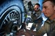 Tech. Sgt. Steven Johnson adjusts the tension as Staff Sgt. Damian Ford, both with the 932nd Maintenance Squadron, assists by helping to hold the oversize wrench in place during a routine tire swap Dec. 29, 2016, Scott Air Force Base, Illinois.  
