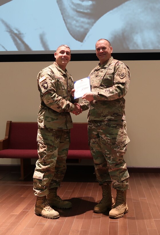 Army Brig. Gen. John S. Laskodi, commanding general, DLA Distribution presents a star note to Army Col. Carleton Birch, DLA Chaplain during the Jan. 19, Martin Luther King, Jr. Event at DLA Distribution Headquarters in New Cumberland, Pa.