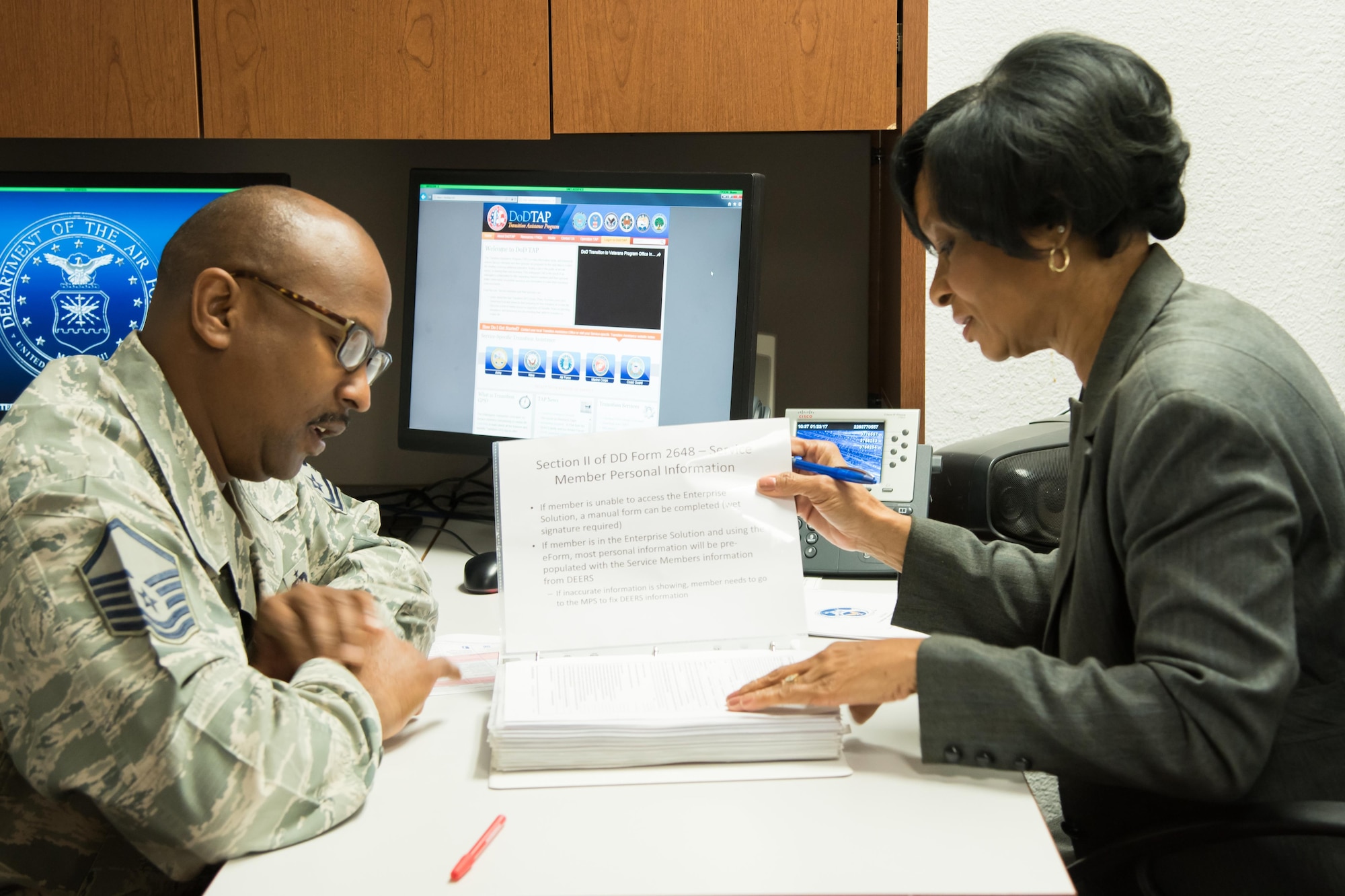 Master Sgt. Michael Coleman, 403rd Wing Airman and Family Readiness Center noncomissioned officer in charge, and Patricia Jackson, 403rd A&FRC section chief, review procedures and programs Jan. 23rd at Keesler Air Force Base, Miss.(U.S. Air Force photo/Staff Sgt. Heather Heiney)