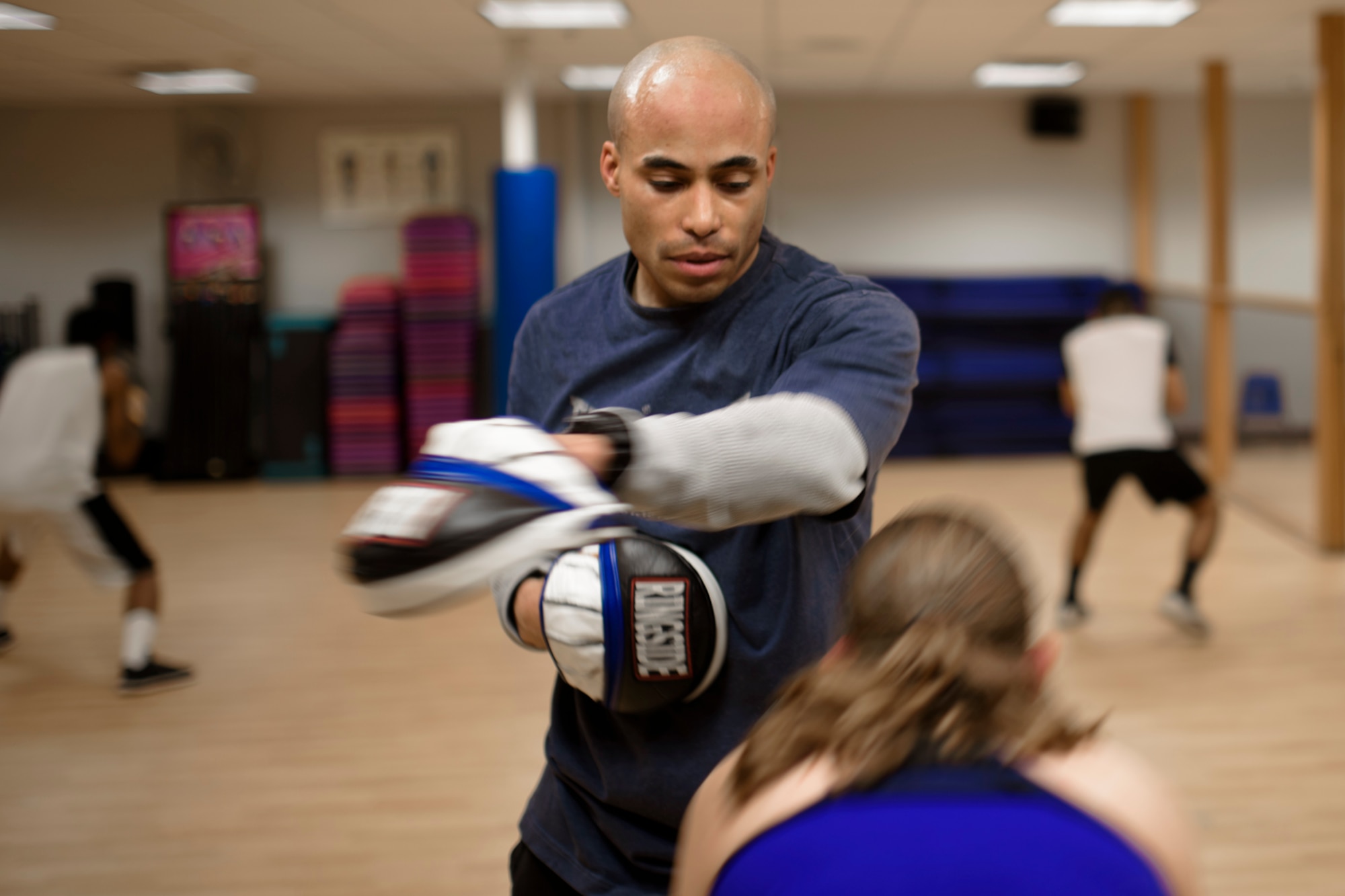 PETERSON AIR FORCE BASE, Colo. – Tech. Sgt. Rosey Summerville, 21st Force Support Squadron fitness NCO in charge, teaches Airmen basic boxing fundamentals and physical fitness in the Fitness Center at Peterson Air Force Base, Colo., Jan. 19, 2017. The class is free and open to all Team Pete service members. (U.S. Air Force photo by Airman 1st Class Dennis Hoffman)