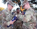 Sgt. 1st Class Antwaun Smith (center) observes as Spc. Christopher Hanna (left) and Pvt. Brady Smith (right) fold a U.S. flag at the Joint Base San Antonio-Fort Sam Houston Quadrangle Clock Tower Jan. 23. A detail of Soldiers from the Army Medical Department Center & School and the Army North Caisson Platoon volunteered to raise, lower, and fold the flags for the post. The flags will be presented as part of the post’s “Lest We Forget” program to commemorate the raid on Cabanatuan prisoner of war camp in the Philippines Jan. 30, 1945.