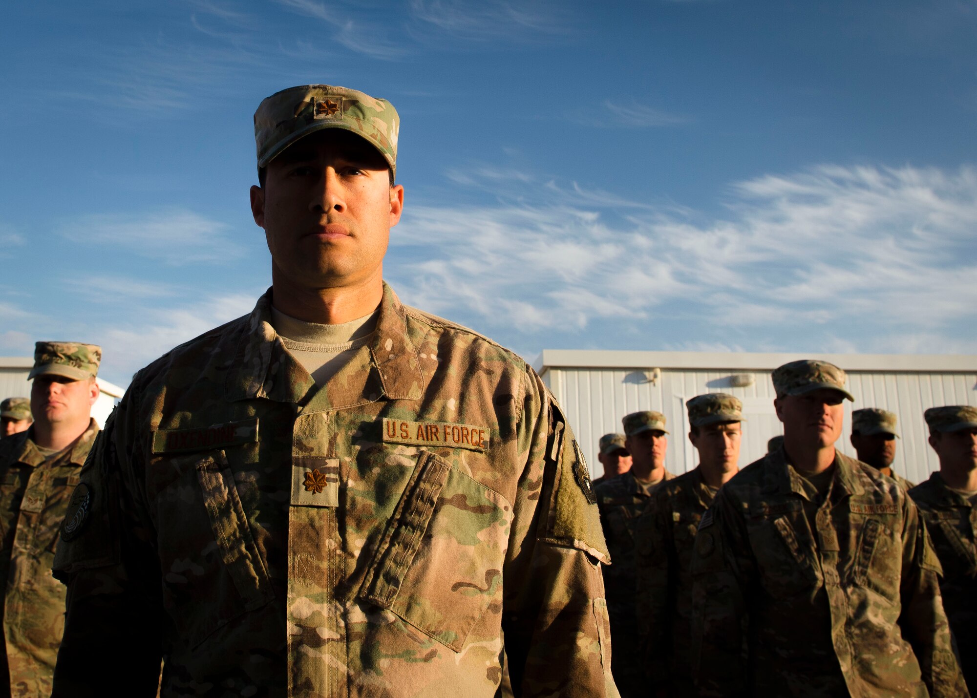 U.S. Air Force Maj. Jimmy Oxendine, 557th Expeditionary Red Horse Squadron site officer in charge, waits for a retreat ceremony to begin Dec. 30, 2016, in Southwest Asia. The retreat ceremony serves as a sign of the end of the duty day and pays respect to the U.S. national flag. (U.S. Air Force photo by Staff Sgt. Eboni Reams)