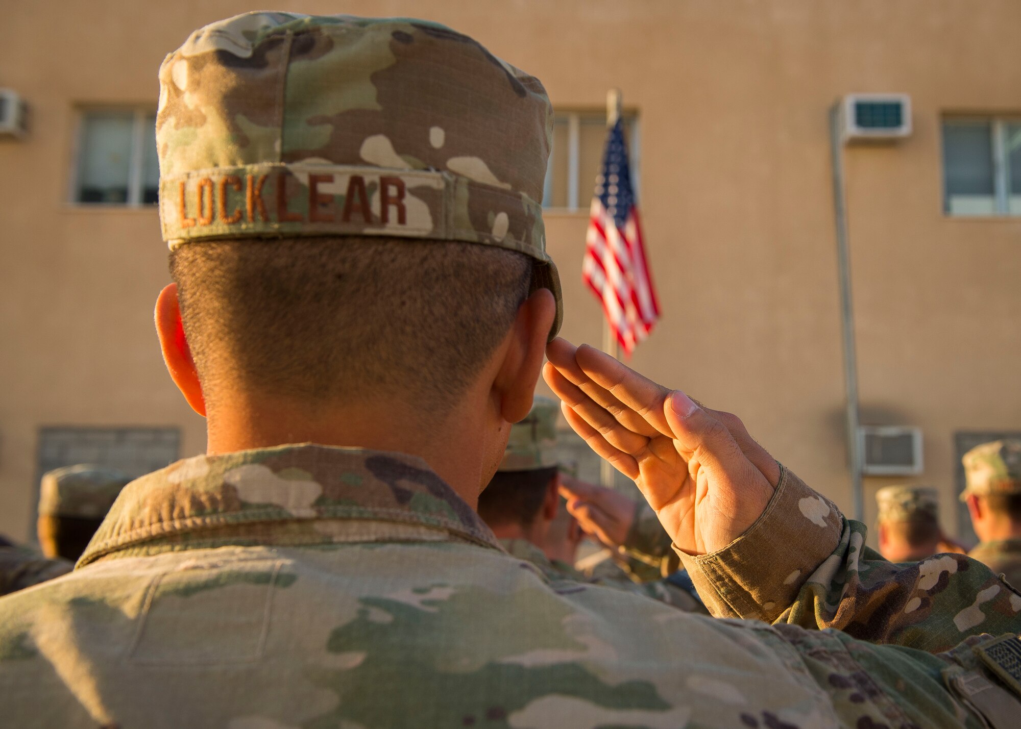 U.S. Air Force Senior Airman Joshua Locklear, 557th Expeditionary Red Horse Squadron, salutes during a retreat ceremony Dec. 30, 2016, in Southwest Asia. The retreat ceremony serves as a sign of the end of the duty day and pays respect to the U.S. national flag. (U.S. Air Force photo by Staff Sgt. Eboni Reams)