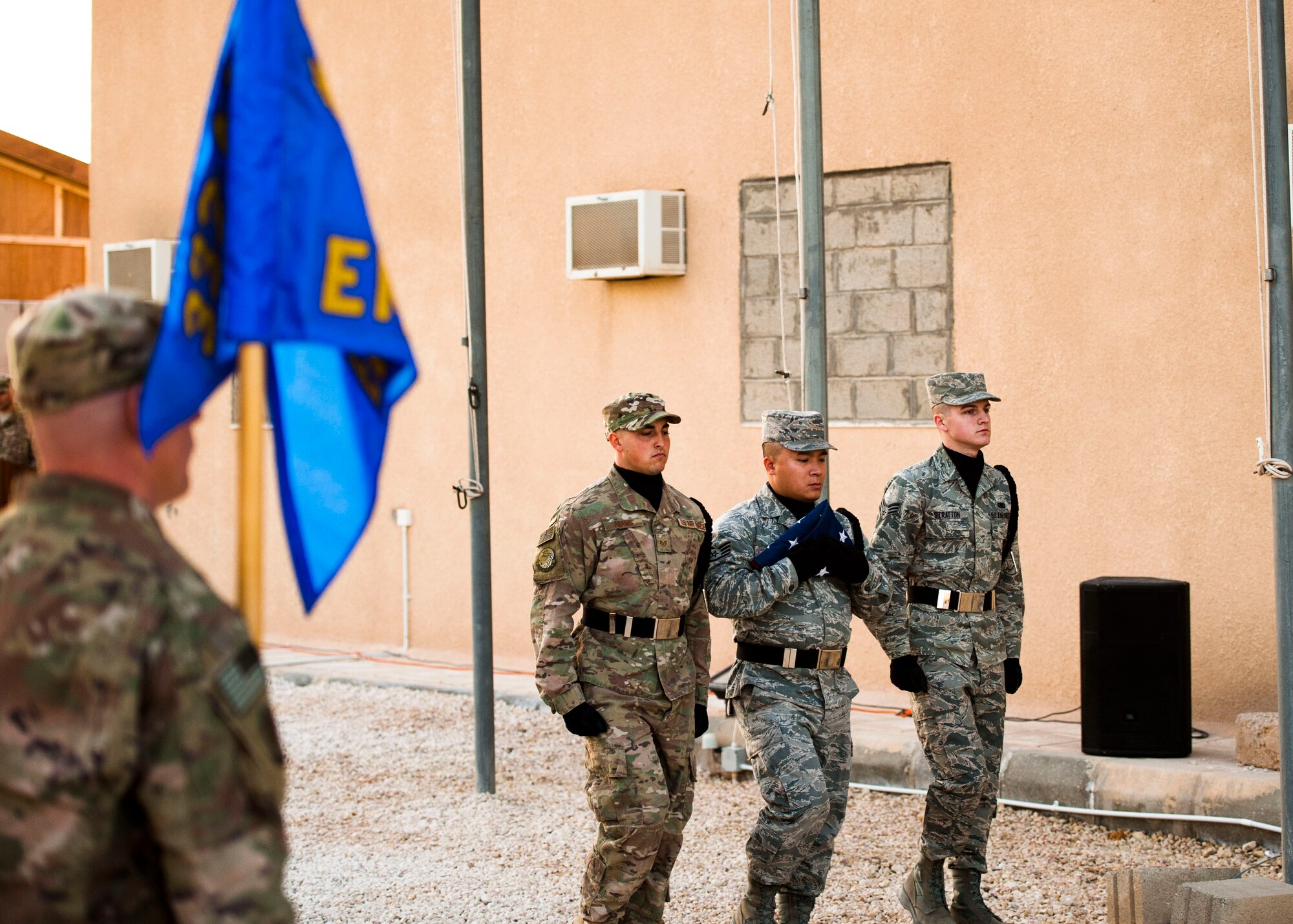 Members from the 332nd Air Expeditionary Wing honor guard retire the colors during a retreat ceremony Dec. 30, 2016, in Southwest Asia. The retreat ceremony serves as a sign of the end of the duty day and pays respect to the U.S. national flag. (U.S. Air Force photo by Staff Sgt. Eboni Reams)