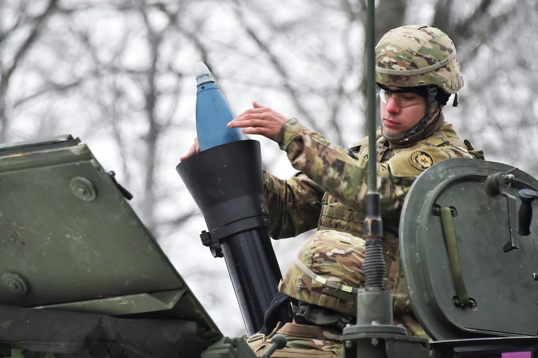 A soldier loads a 120 mm mortar round at the 7th Army Training Command’s Grafenwoehr Training Area in Germany, Jan. 24, 2017. Army photo by Gertrud Zach