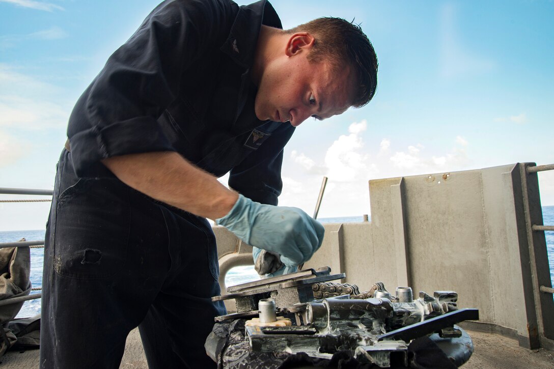 Navy Petty Officer 3rd Class Jacob Bell performs post-fire maintenance on a 25 mm machine gun system aboard the aircraft carrier USS Carl Vinson in the Pacific Ocean, Jan. 23, 2017. Bell is a gunner’s mate. Navy photo by Petty Officer 3rd Class Elton Charles Wheeler