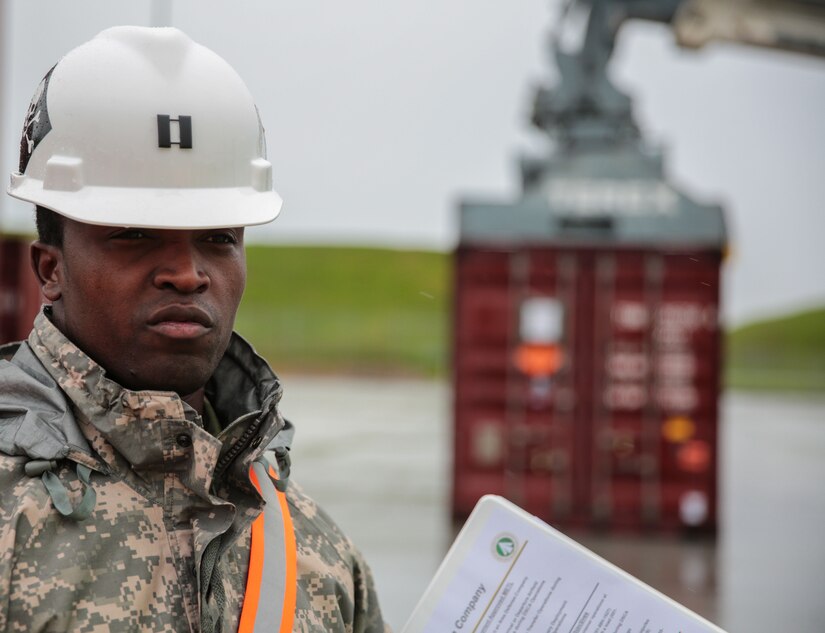 Capt. Furaha Mujacera, the 939th Transportation Company commander, briefs visitors about how his company supports the 1189th Transportation Surface Brigade at Military Ocean Terminal Concord, California, by discharging, loading and transshipping ammunition containers by Department of Defense Identification Code and weight, Jan. 18, 2017.