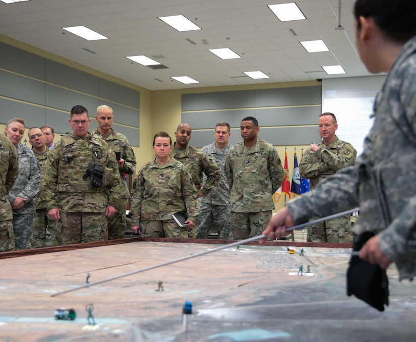 Maj. Maria McDougal gives a portion of the 834th Transportation Battalion's concept of operations brief to senior officials that include, from left, Brig. Gen. Lathrop, California Army National Guard; Maj. Gen. Beth Austin, Army Materiel Command Assistant Deputy Commanding General, Army National Guard; and Maj. Gen. Kurt J. Ryan, commander, Military Surface Deployment and Distribution Command, during the opening of Operation Patriot Bandoleer at Military Ocean Terminal Concord, California, Jan. 18. Task Force Golden Patriot is an Active Army, Army Reserve and Army National Guard joint effort to transport ammunition from MOTCO to pre-determined locations throughout the United States in support of Operation Patriot Bandoleer.