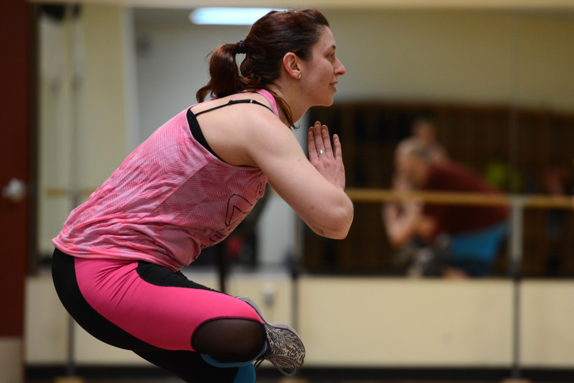 Jessica Pisano, Joint Base Elmendorf-Richardson Fitness lead group-exercise instructor, demonstrates a stretch at the end of a Zumba class at the Elmendorf Fitness Center at JBER, Alaska, Jan. 17, 2017. All group-exercise classes last approximately an hour and welcome participants of all skill levels who are 16 years older with base access.