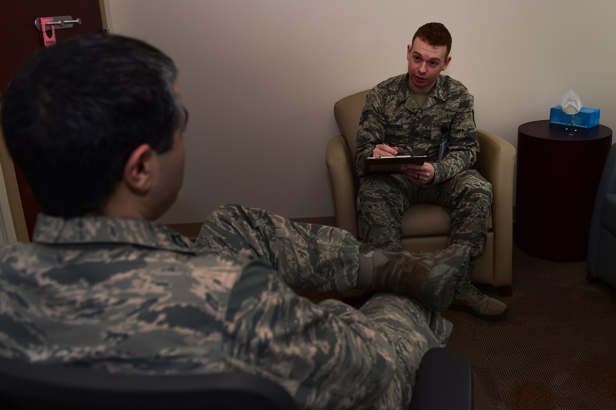Staff Sgt. Christopher Durkin, 460th Medical Group Air Force Alcohol and Drug Abuse Prevention and Treatment NCO in charge, speaks to Capt. Robert Justiniano, 460th MDG ADAPT manager, Jan. 20, 2017, at the Veterans Affairs Joint Venture Buckley Clinic in Aurora, Colo. Justiniano and Durkin must have constant communication about the ADAPT program to ensure patients are receiving the necessary care. (U.S. Air Force photo by Airman 1st Class Gabrielle Spradling/Released)