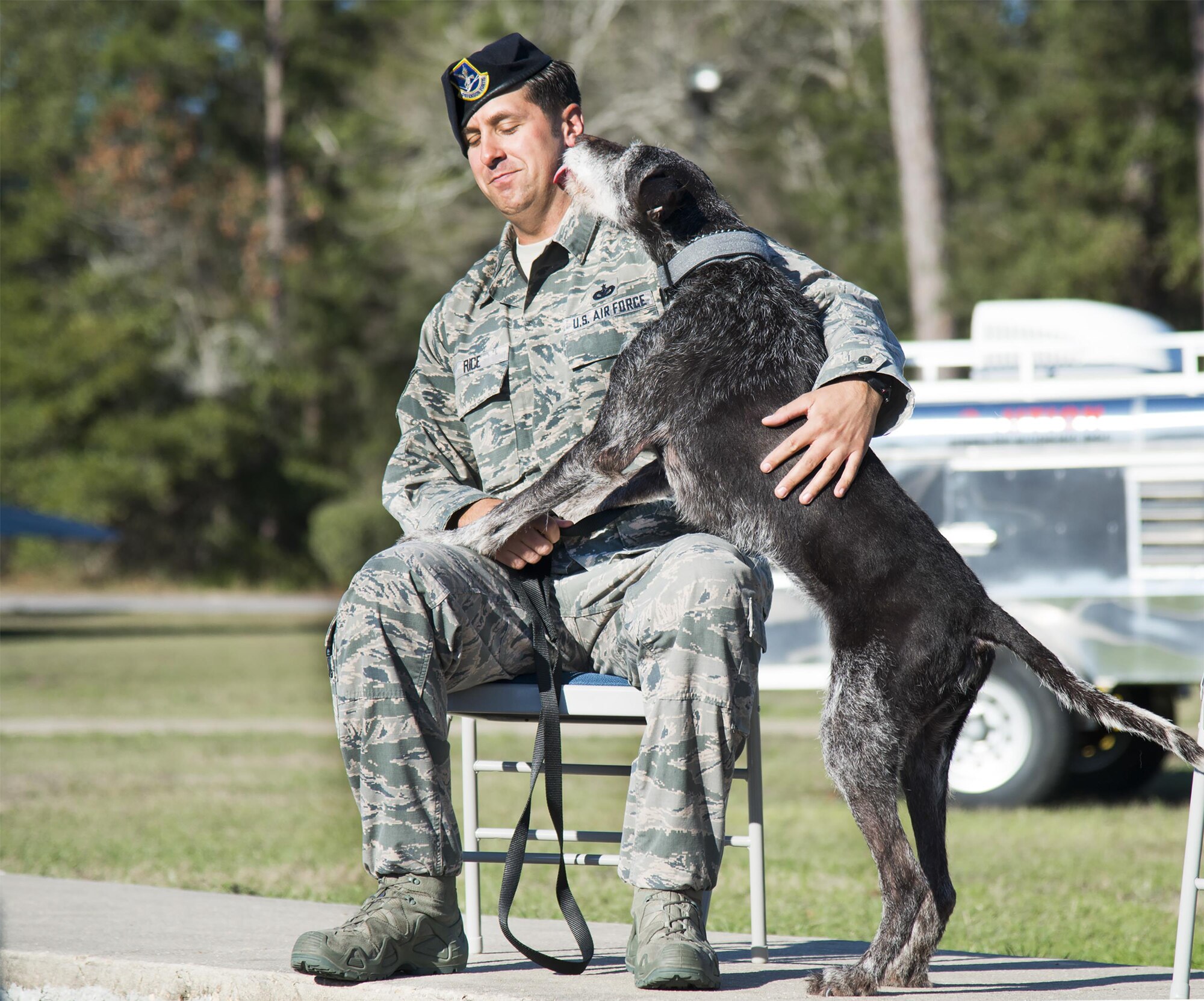 Kanjer expresses his gratitude to Staff Sgt. Jeremy Rice for his adoption during the military working dog’s retirement ceremony January 23, at Eglin Air Force Base, Fla. Rice, an active duty dog handler at Patrick Air Force Base, was one of Kanjer’s handlers for four years. (U.S. Air Force photo/Cheryl Sawyers)