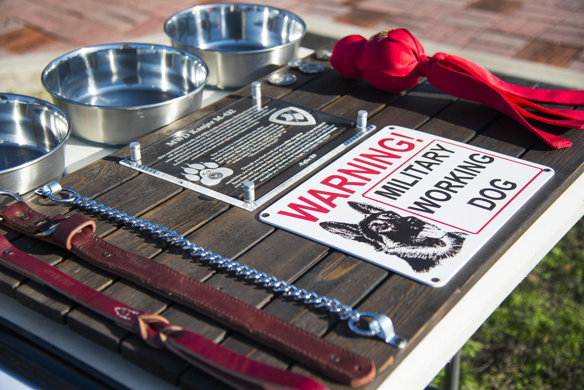 In honor of Military Working Dog Kanjer’s service, the Airmen at the 96th Security Forces Squadron presented him with a plaque January 23, at Eglin Air Force Base, Fla. The plaque contained his leash and favorite toy among other items of significance. (U.S. Air Force photo/Cheryl Sawyers) 