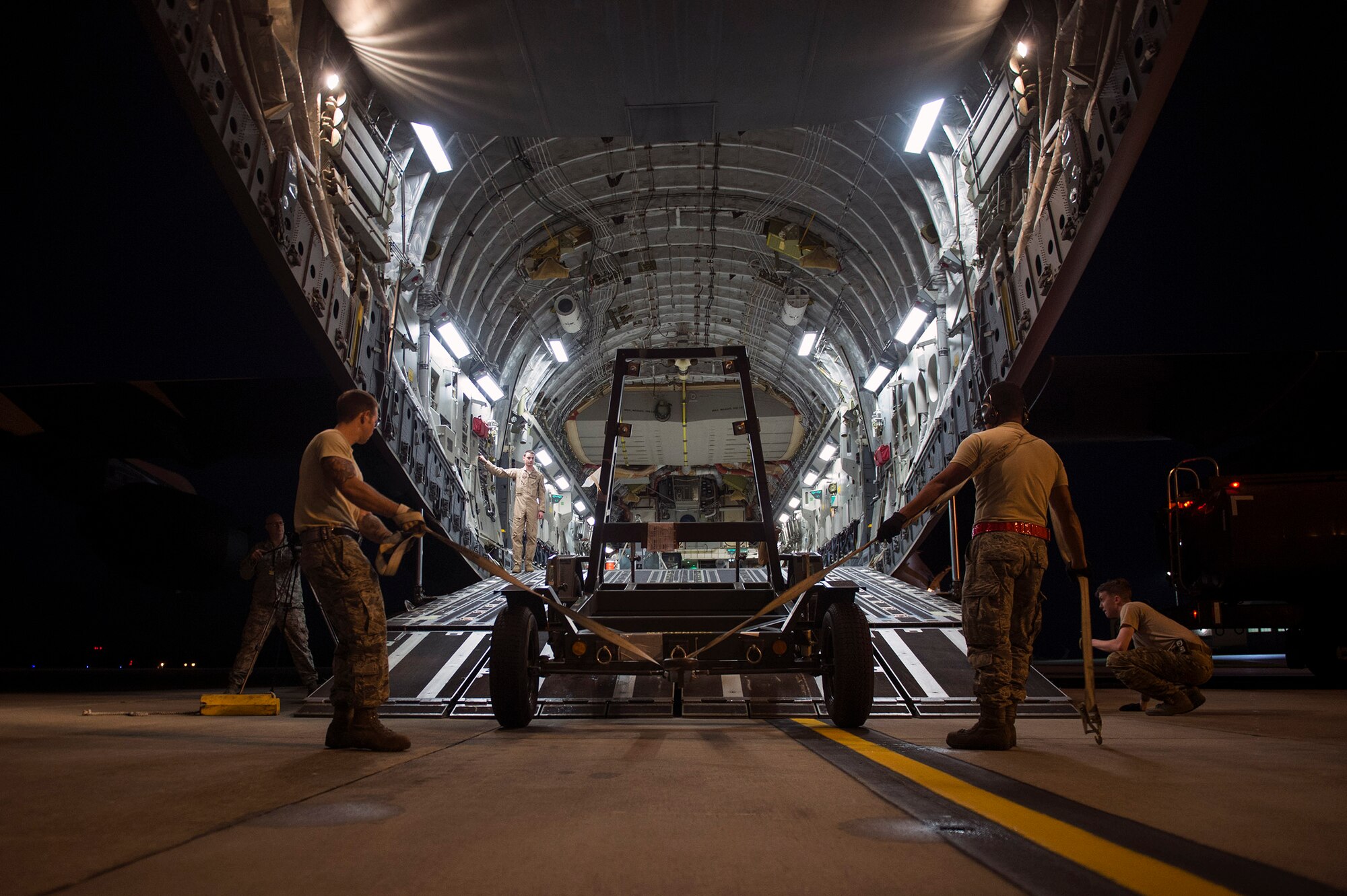 Moody’s 23d Logistic Readiness Squadron’s air transportation specialists load cargo onto a C-17 Globemaster III in support of the 41st Rescue Squadron’s deployment, Jan. 23, 2017, at Moody Air Force Base, Ga. These Airmen loaded and secured cargo for transport for the 41st RQS’ expeditionary efforts in Southeast Europe. (U.S. Air Force photo by Airman 1st Class Greg Nash)