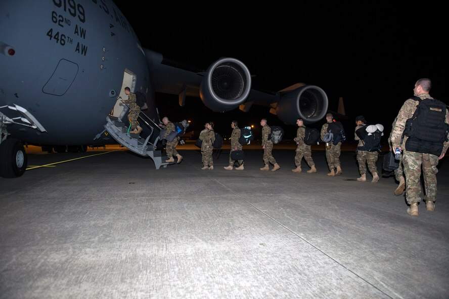 Moody warriors board a C-17 Globemaster III as they deploy to Southeast Europe in support of the 41st Rescue Squadron, Jan. 23, 2017, at Moody Air Force Base, Ga. The 41st RQS mission is to rapidly mobilize and provide search and rescue support of personnel, and to treat and extract in uncertain or possibly hostile territories. (U.S. Air Force photo by Airman 1st Class Greg Nash)