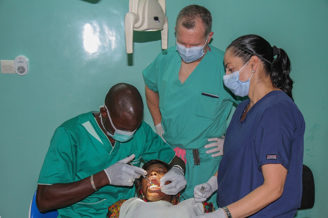 Senegalese dentist Pape Djibril Gueye administers a local anesthetic while Vermont Air National Guard flight surgeon Thomas Sterling and U.S. Army Reserve Master Sgt. Jacqueline Fortin, a dental specialist from the 332nd Medical Brigade in Nashville, Tenn., observe during Medical Readiness Training Exercise 17-1 at La Sante des Armees Hospital in Dakar, Senegal, Jan. 12, 2017. MEDRETE is a combined effort between the Senegalese government, U.S. Army Africa, the U.S. Army Reserve 332nd Medical Brigade in Nashville, Tenn., and the Vermont Air National Guard. MEDRETE 17-1 is the first in a series of medical readiness training exercises that U.S. Army Africa is scheduled to facilitate within various countries in Africa, and serves as an opportunity for the partnered militaries to hone and strengthen their general surgery and trauma skills while reinforcing the partnership between the countries. The mutually beneficial exercise brings together Senegalese military and U.S. Army medical professionals to foster cooperation while conducting medical specific tasks. (U.S. Army Africa photo by Maj. Simon Flake)