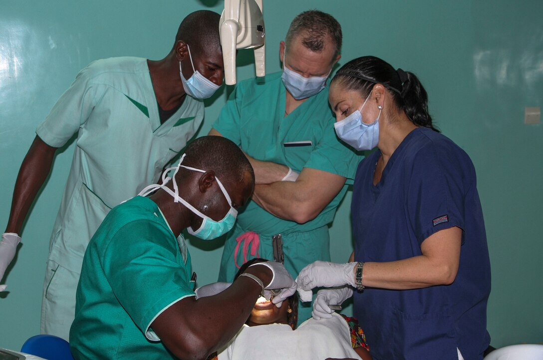 Senegalese dentist Pape Djibril Gueye administers a local anesthetic while Vermont Air National Guard flight surgeon Thomas Sterling and U.S. Army Reserve Master Sgt. Jacqueline Fortin, a dental specialist from the 332nd Medical Brigade in Nashville, Tenn., observe during Medical Readiness Training Exercise 17-1 at La Sante des Armees Hospital in Dakar, Senegal, Jan. 12, 2017. MEDRETE is a combined effort between the Senegalese government, U.S. Army Africa, the U.S. Army Reserve 332nd Medical Brigade in Nashville, Tenn., and the Vermont Air National Guard. MEDRETE 17-1 is the first in a series of medical readiness training exercises that U.S. Army Africa is scheduled to facilitate within various countries in Africa, and serves as an opportunity for the partnered militaries to hone and strengthen their general surgery and trauma skills while reinforcing the partnership between the countries. The mutually beneficial exercise brings together Senegalese military and U.S. Army medical professionals to foster cooperation while conducting medical specific tasks. (U.S. Army Africa photo by Maj. Simon Flake)
