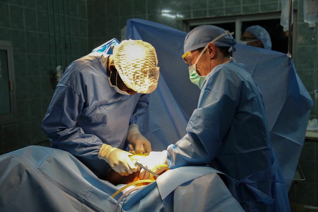 U.S. Air National Guard Maj. Anthony Donaldson, a surgeon from the Vermont Air National Guard in Burlington, Vermont, and Senegalese gynecologist Mansour Niang, conduct a laparoscopic salpingectomy to remove an obstructed fallopian tube during Medical Readiness Training Exercise 17-1 at La Sante des Armees Hospital in Dakar, Senegal, Jan. 13, 2017. MEDRETE is a combined effort between the Senegalese government, U.S. Army Africa, the U.S. Army Reserve 332nd Medical Brigade in Nashville, Tenn., and the Vermont Air National Guard. AFRICOM’s MEDRETEs hosted by United States Army-Africa pair small teams of military medical professionals from the U.S. with participating African partner nations to train alongside and share best practices in trauma and surgical medicine. U.S. personnel; benefit by providing medical care in a forward and austere environment; African partners develop closer relations ships with medical personnel, and local populations receive additional medical care. (U.S. Army Africa photo by Maj. Simon Flake)