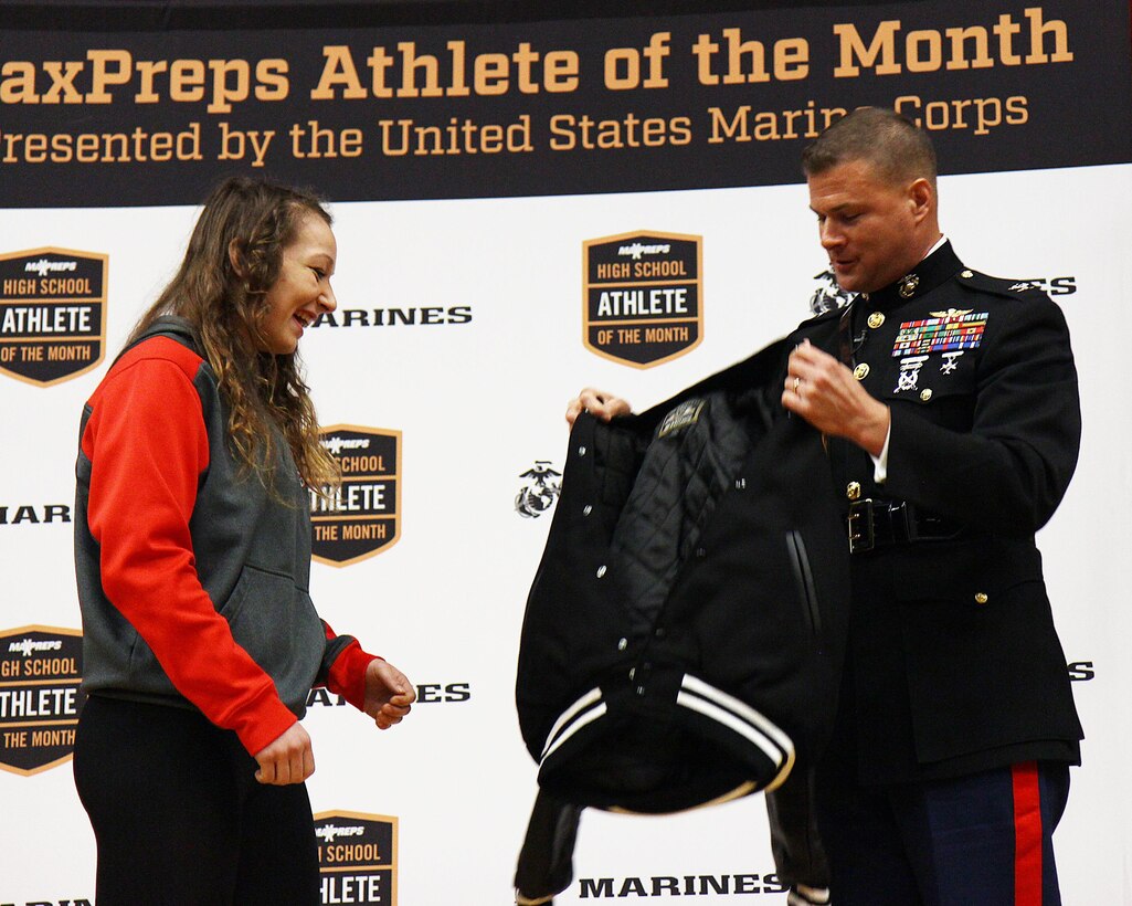 Col. Terry M. Johnson, commanding officer of the 12th Marine Corps District, recognizes Emma Bruntil, a junior and competetive wrestler at Mt. Baker High School, as the MaxPreps High School Athlete of the Month during a ceremony at Mt. Baker High School, Jan. 23. Bruntil was also nominated for the Semper Fidelis All-American Program and, if selected, earns an opportunity to attend the Battles Won Academy in Washington, D.C.