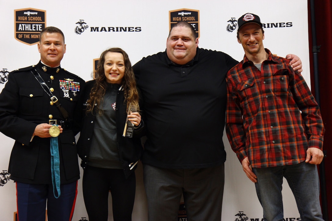 Emma Bruntil stands with Col. Terry M. Johnson, American olympian Rulon Gardner, and her father Craig Bruntil, after being recognized as the MaxPreps High School Athlete of the Month, Jan. 23. Gardner is an Olympic Gold and Bronze medalist in Greco-Roman wrestling and Johnson is the commanding officer of the 12th Marine Corps District.